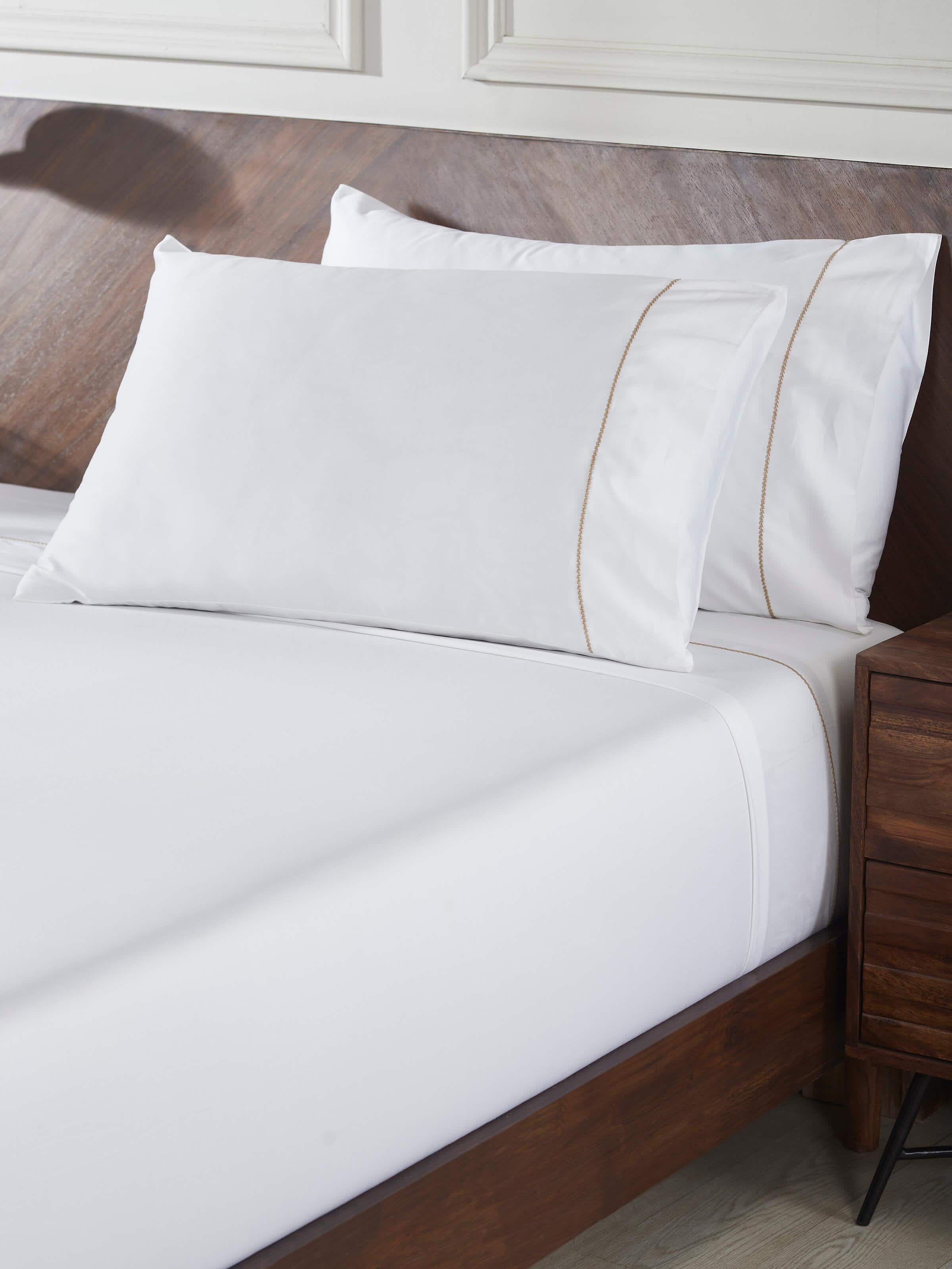 Detailed view of Shivranjini beige stripe cotton hand embroidered bedsheet king set, focusing on the fabric texture and embroidery details.