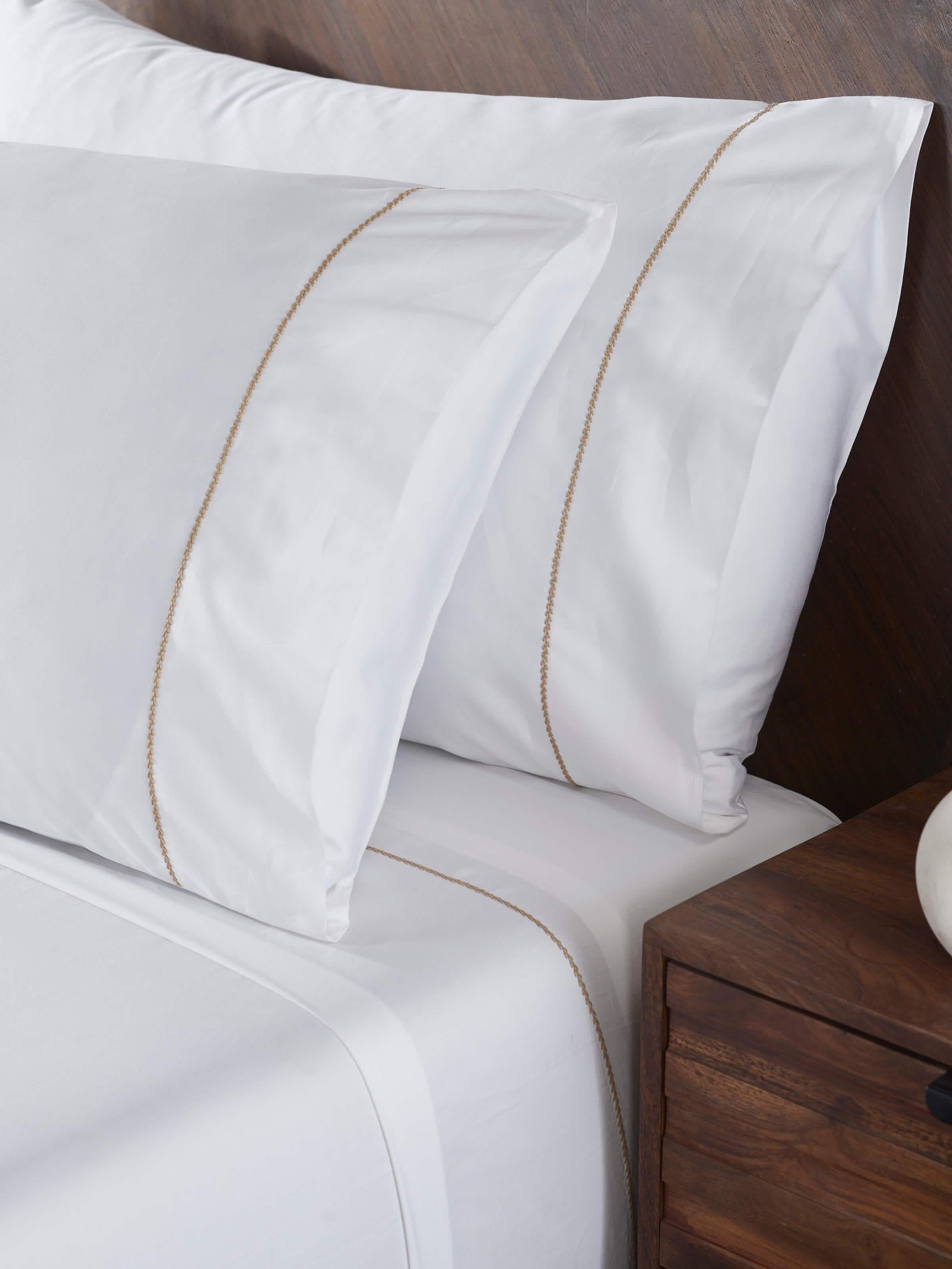 Close-up of Shivranjini beige stripe cotton hand embroidered bedsheet king set, highlighting the fine embroidery work and striped pattern.