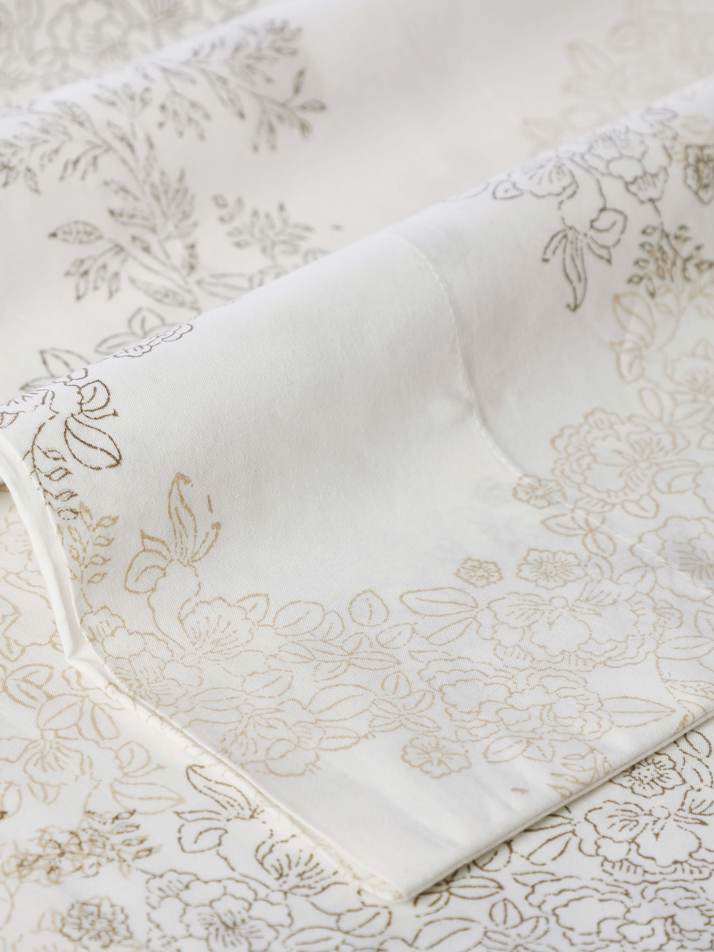 Full set of Shivranjini beige trellis cotton Sanganeri block printed king bedsheet set displayed on a bed