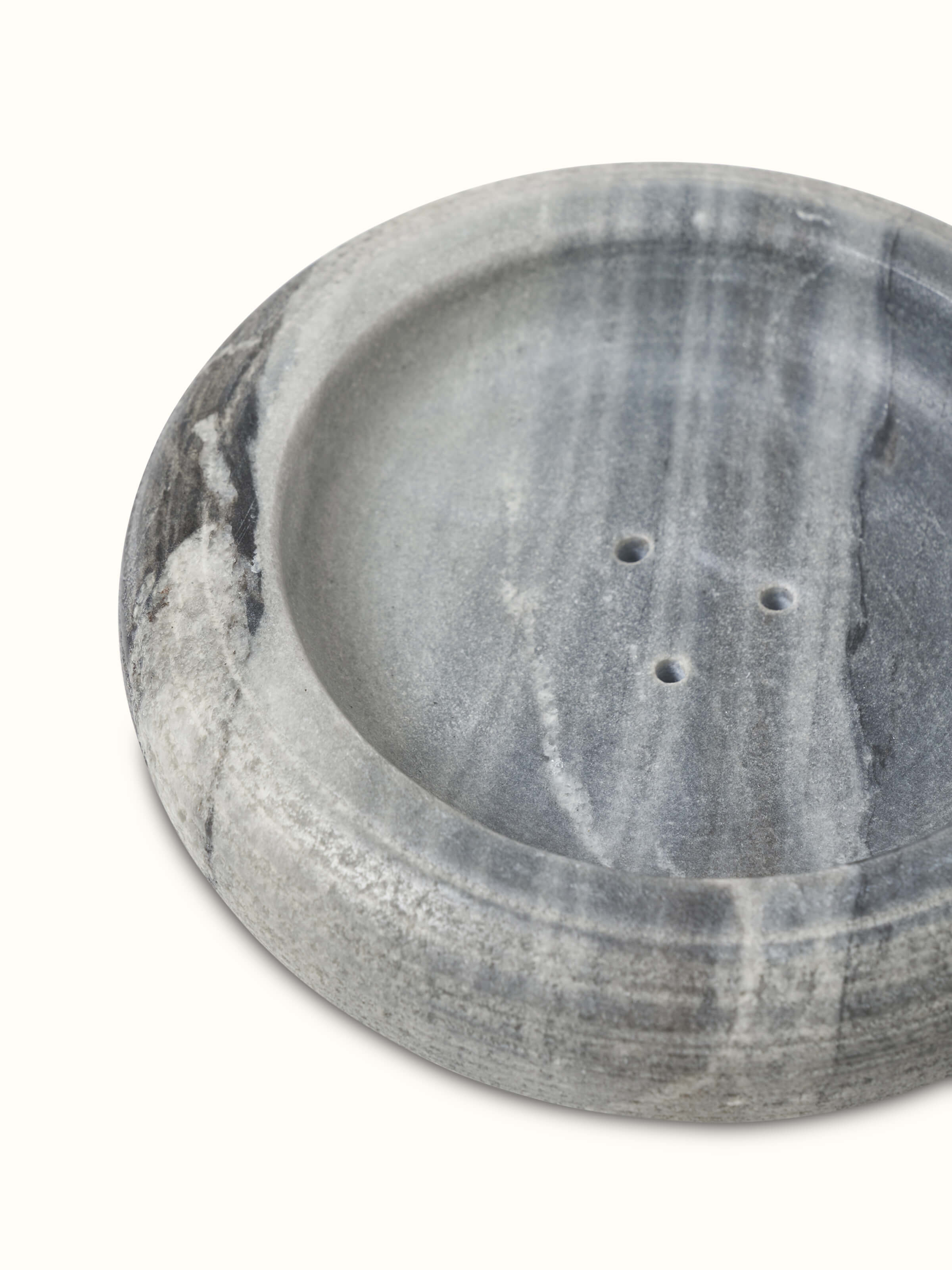 Detailed view of grey carved marble soap dish displaying elegant carvings