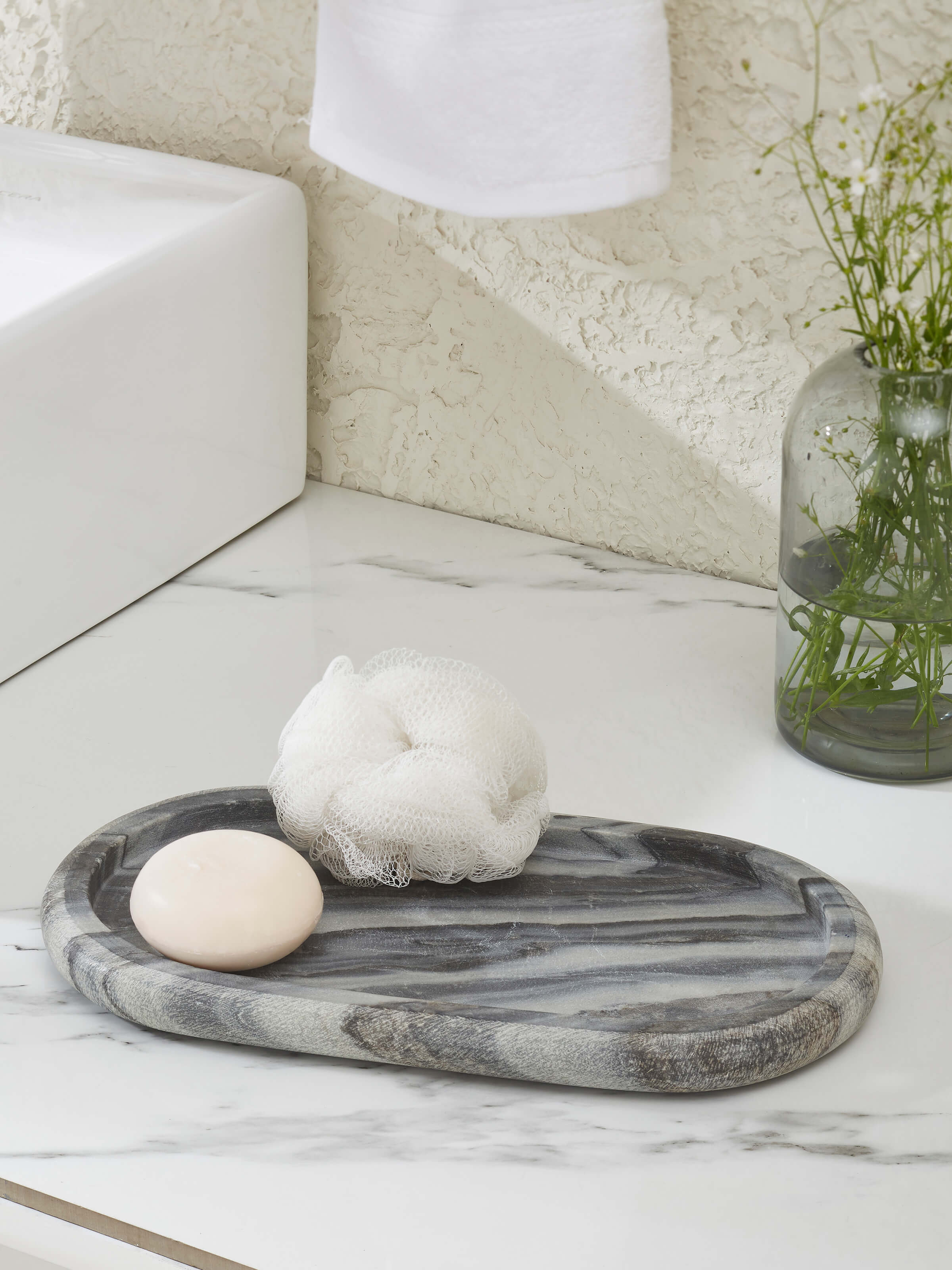 Side view of carved marble bath tray in grey color highlighting its detailed carving