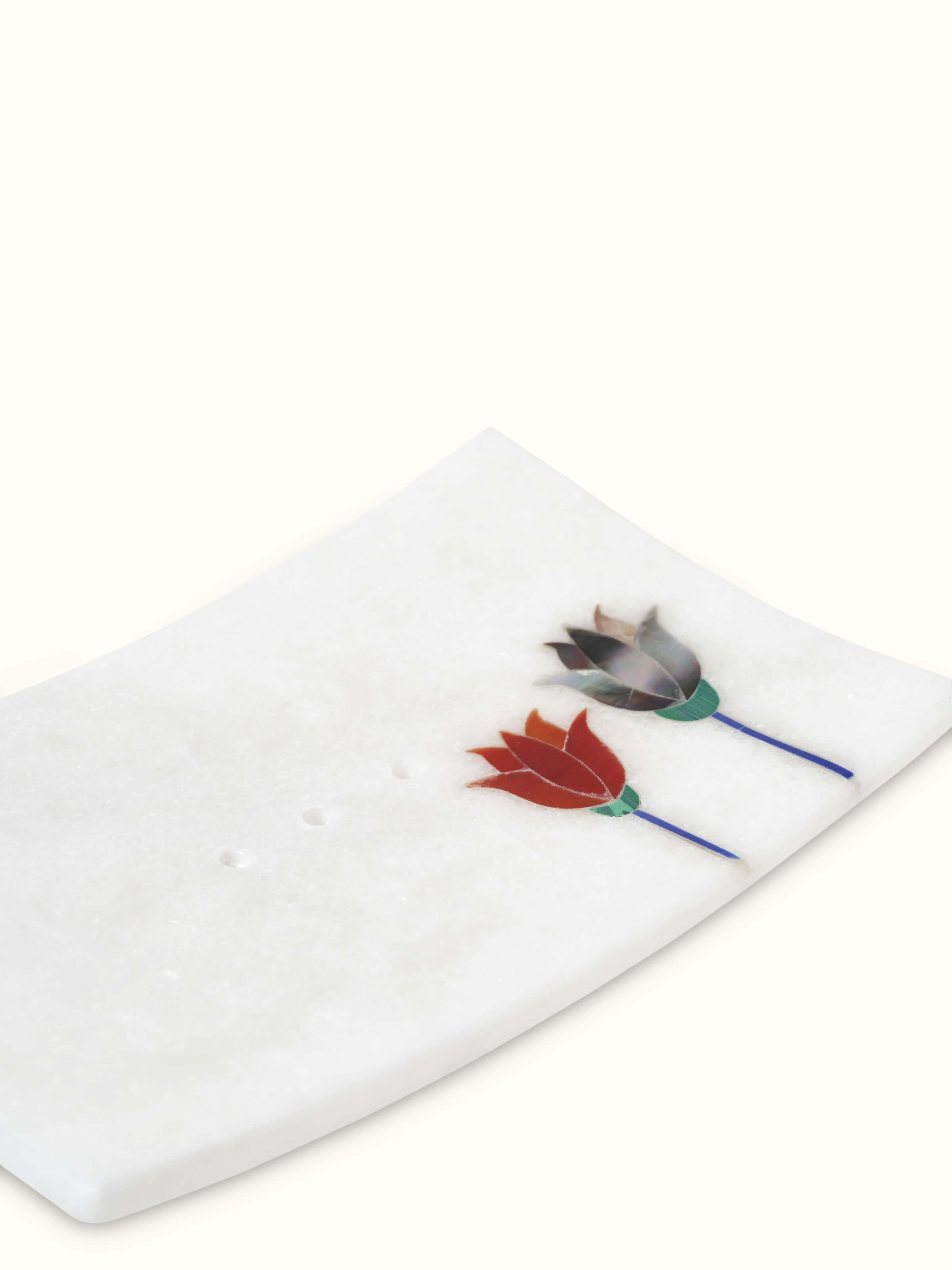 Close-up of carved Ambaji white marble lotus soap dish highlighting the marble's intricate details.