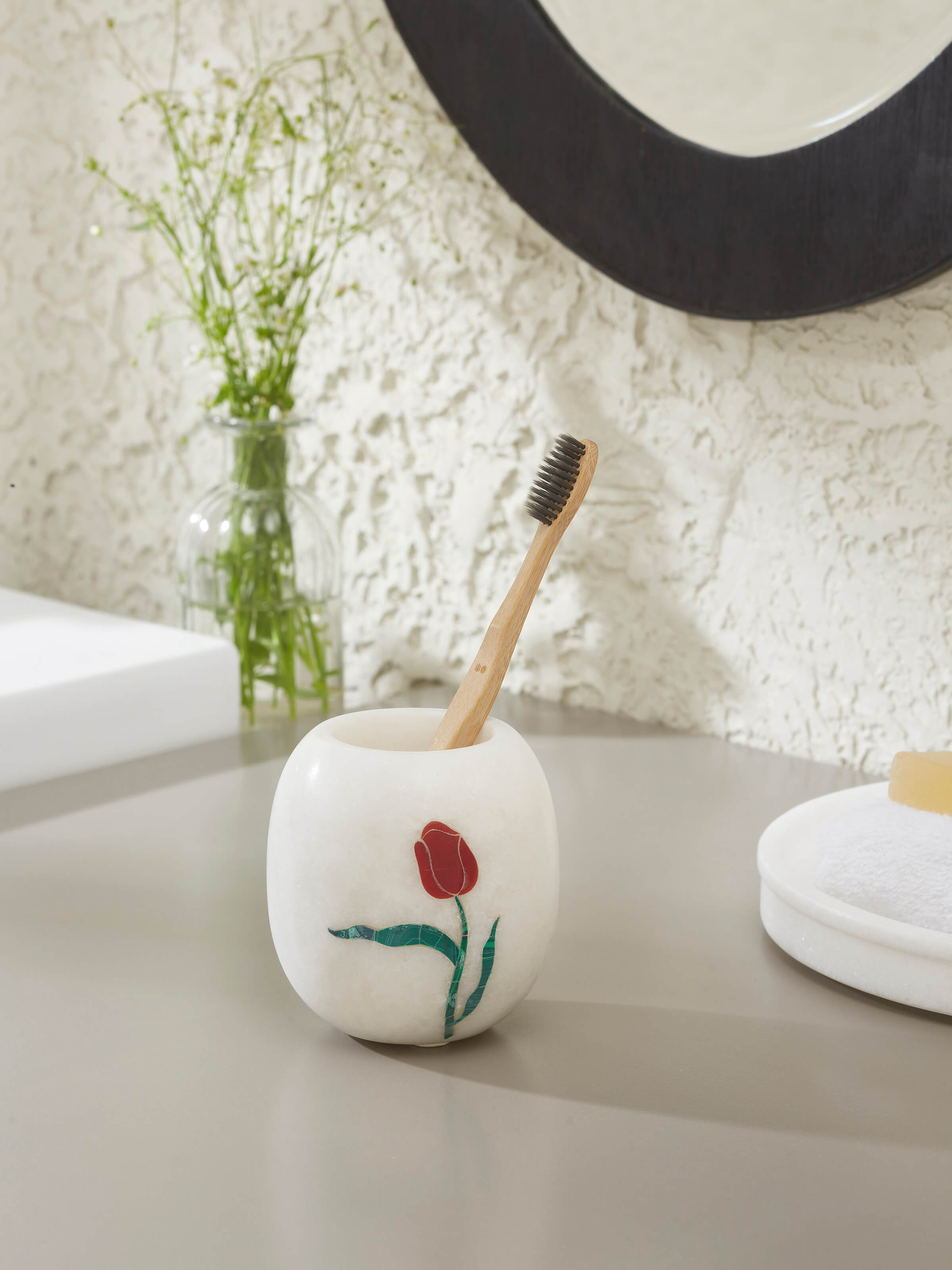 Side view of Carved Ambaji white marble rose toothbrush holder highlighting intricate carving details.