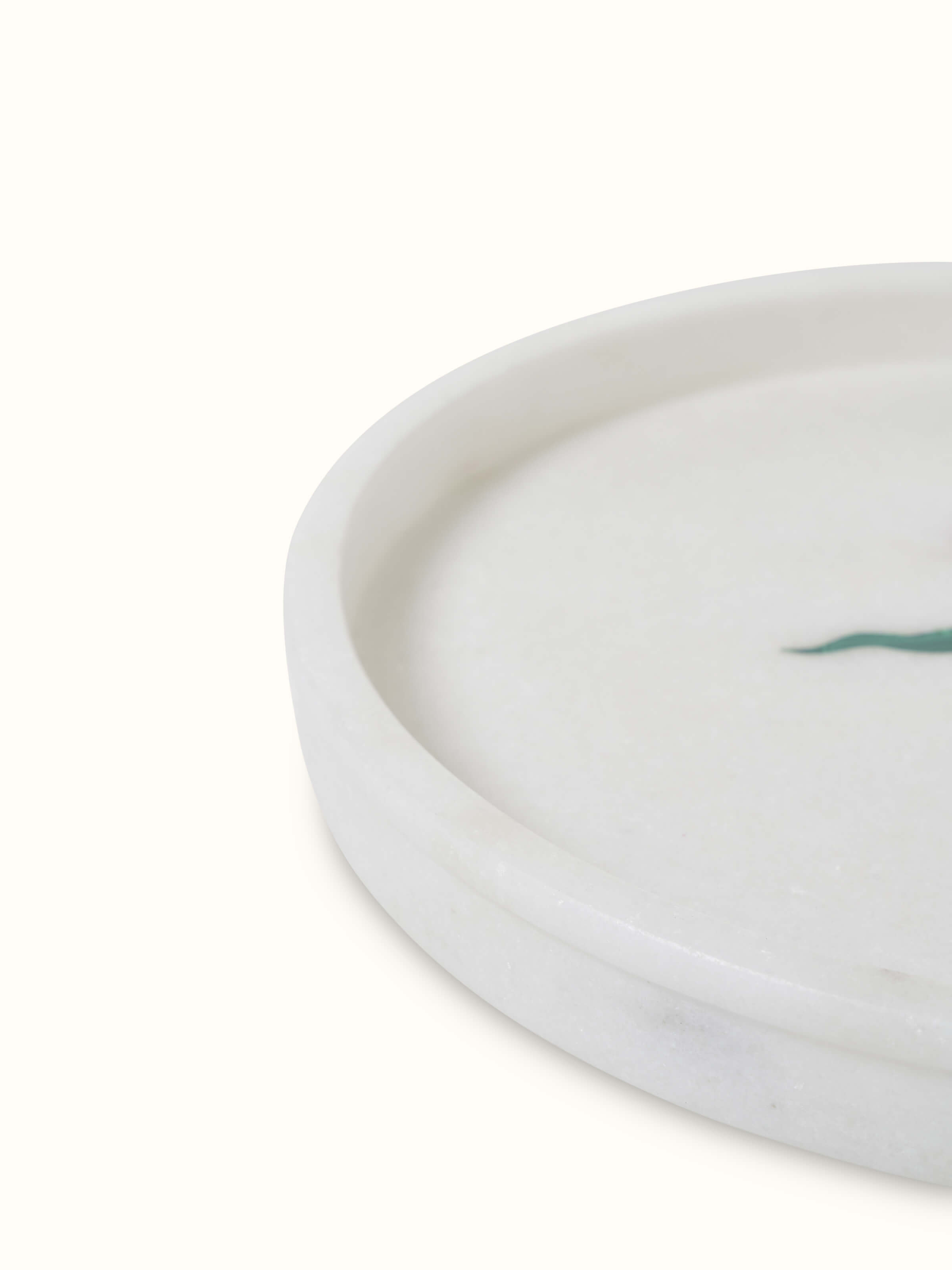 Close-up view of white carved Ambaji marble bath tray with elegant carvings