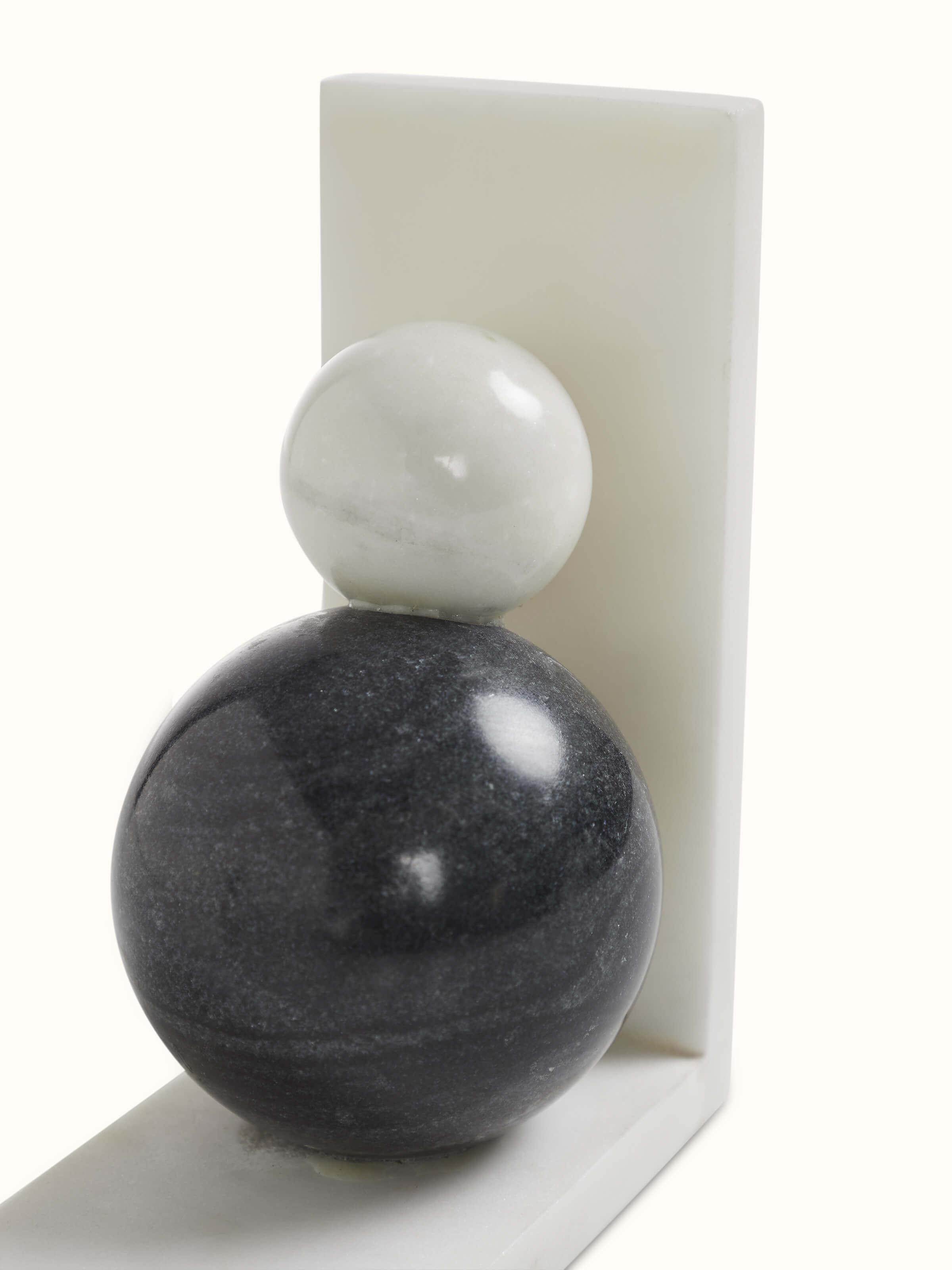 Close-up of carved marble bookend in white color highlighting intricate carving details