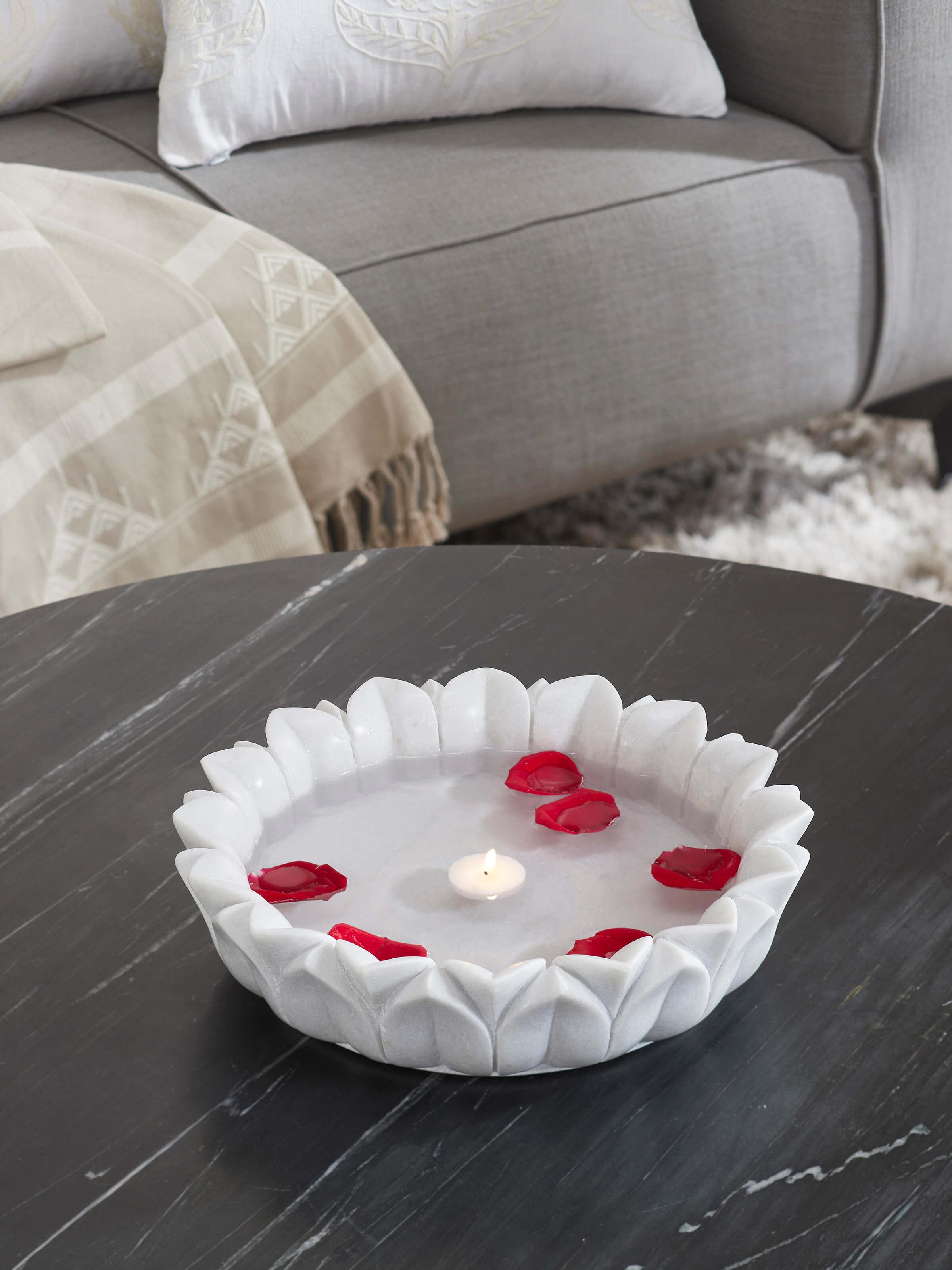 Side view of Glossy Carved Marble Urli highlighting detailed craftsmanship.