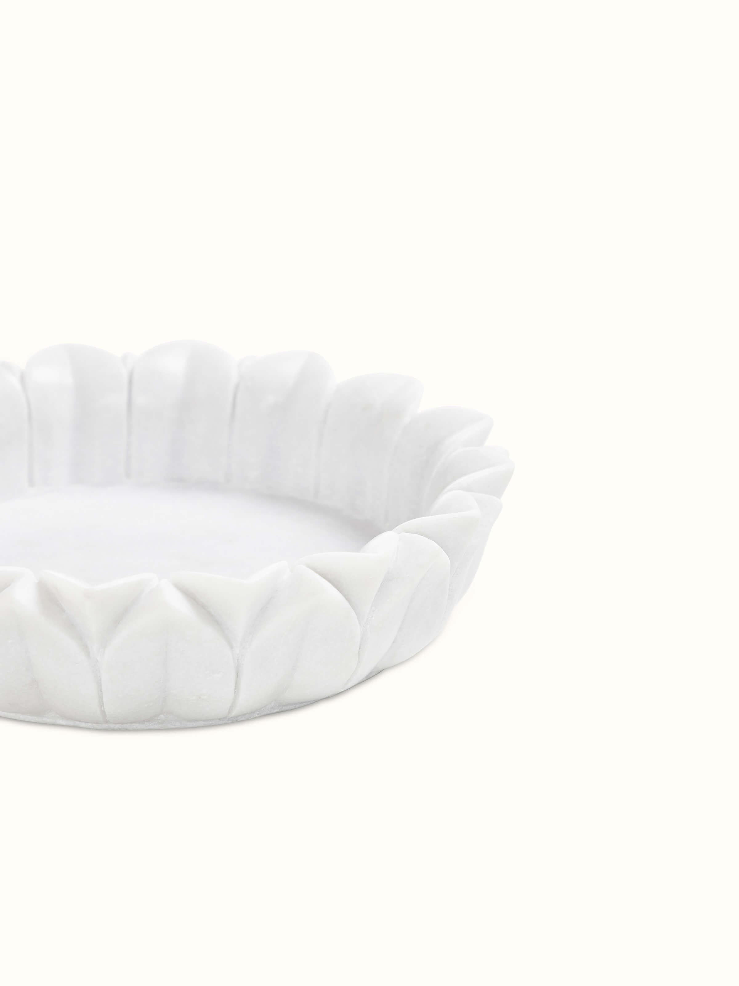 Detailed view of Glossy Carved Marble Urli emphasizing its smooth finish.