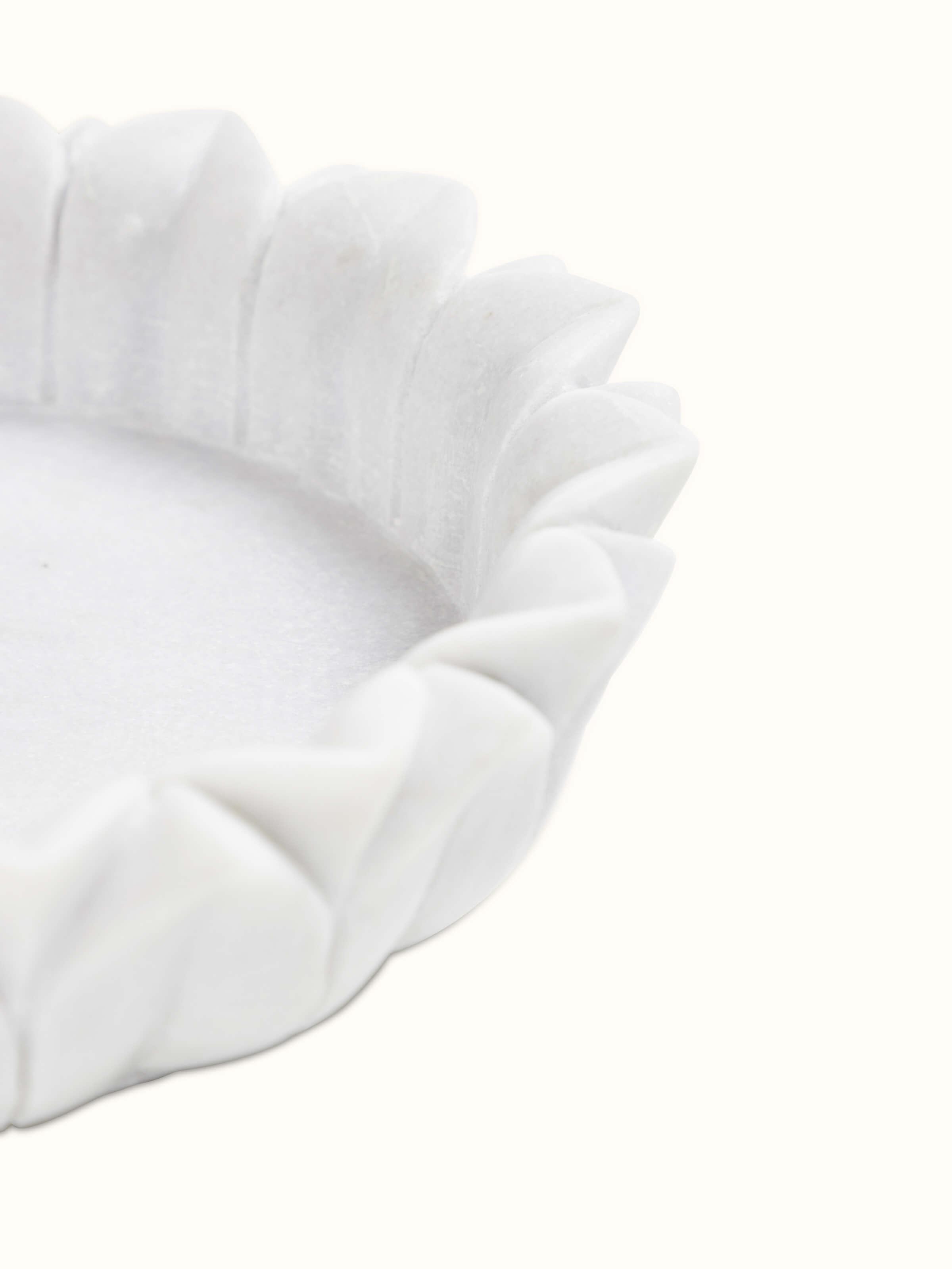 Close-up of Glossy Carved Marble Urli showcasing elegant design details.