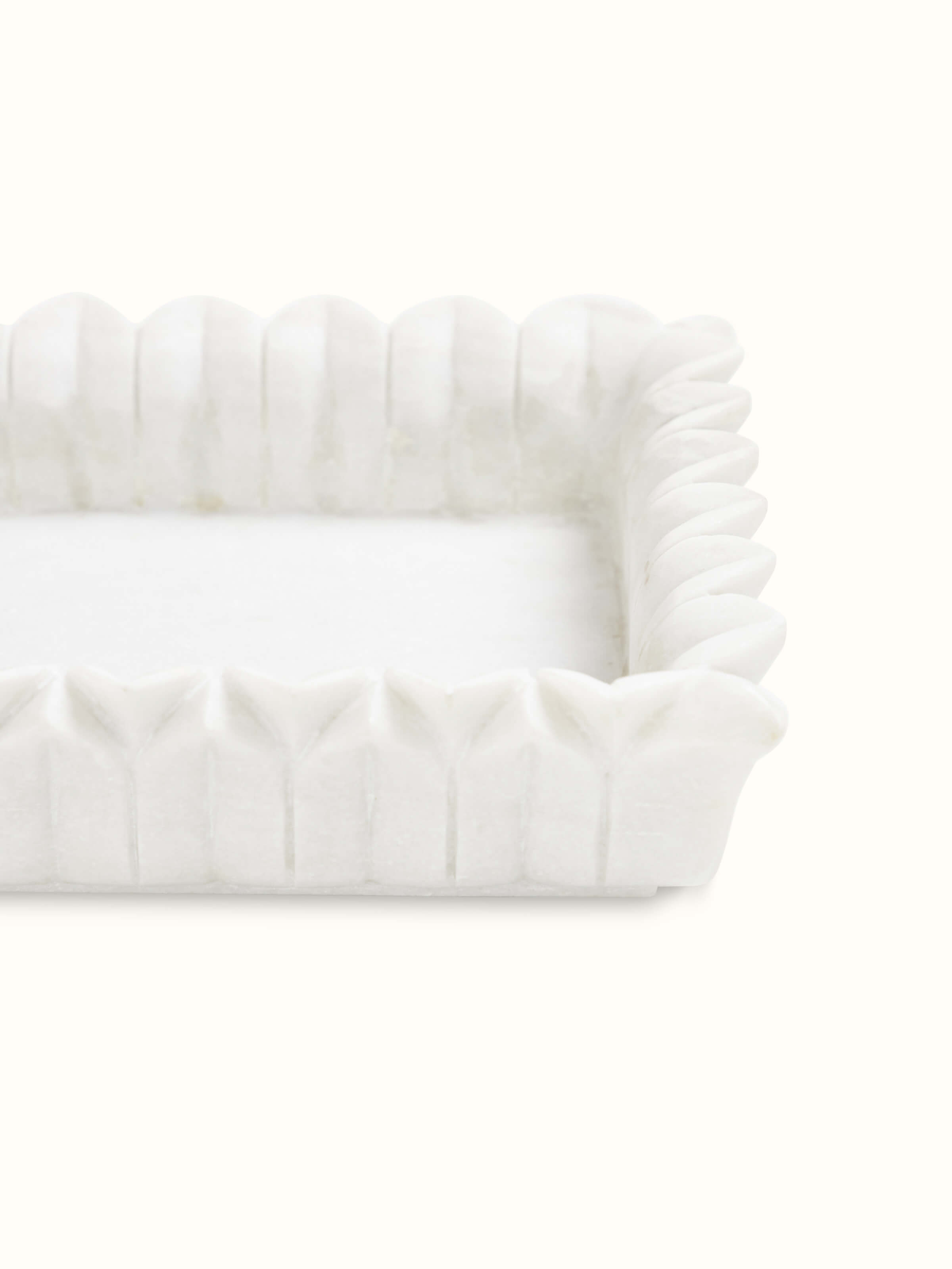 Detailed view of the artistic carving on rectangular marble urli