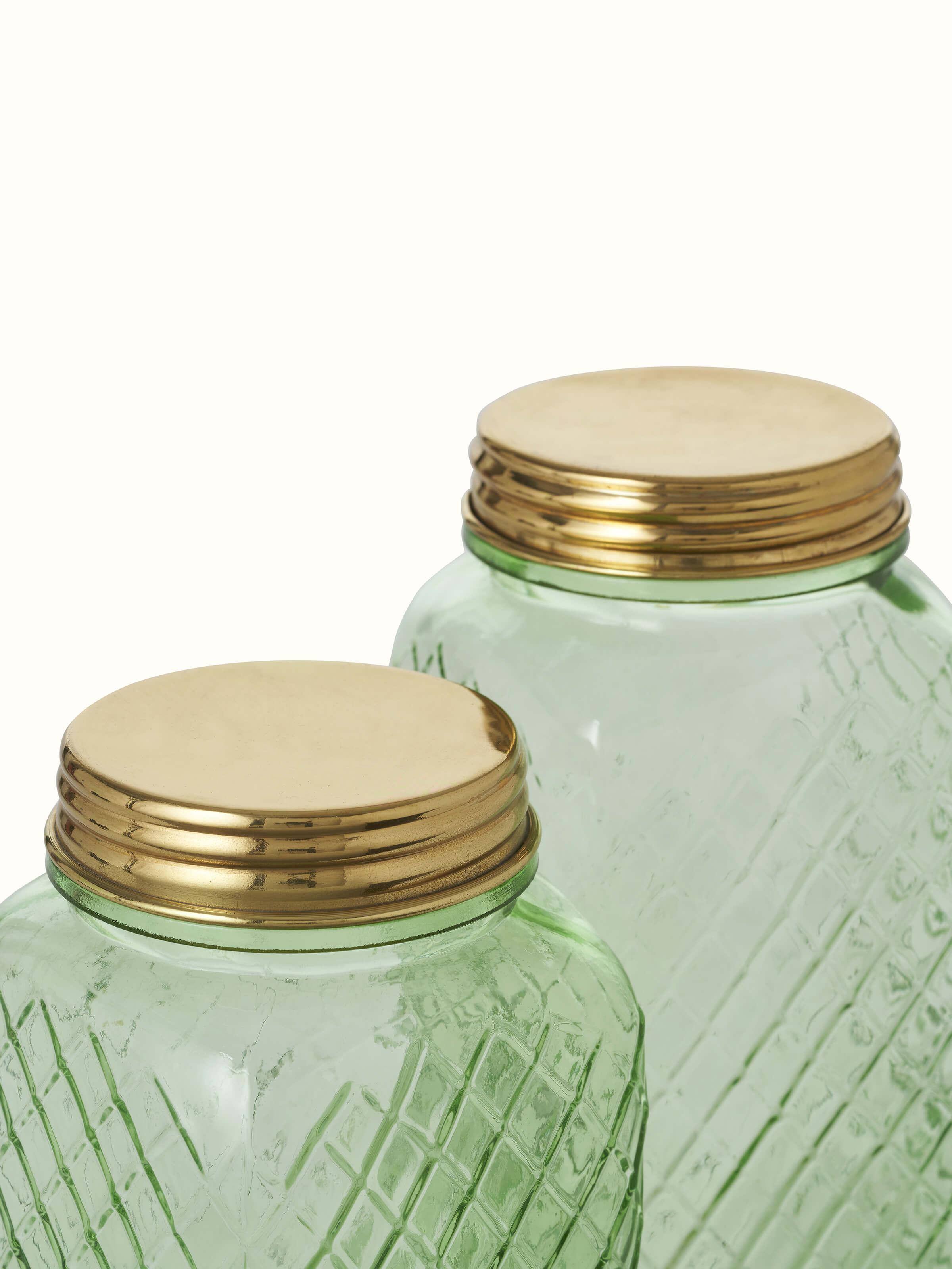 Artistic view of green glass-worked storage containers, set of 2, displaying the vibrant color and design.
