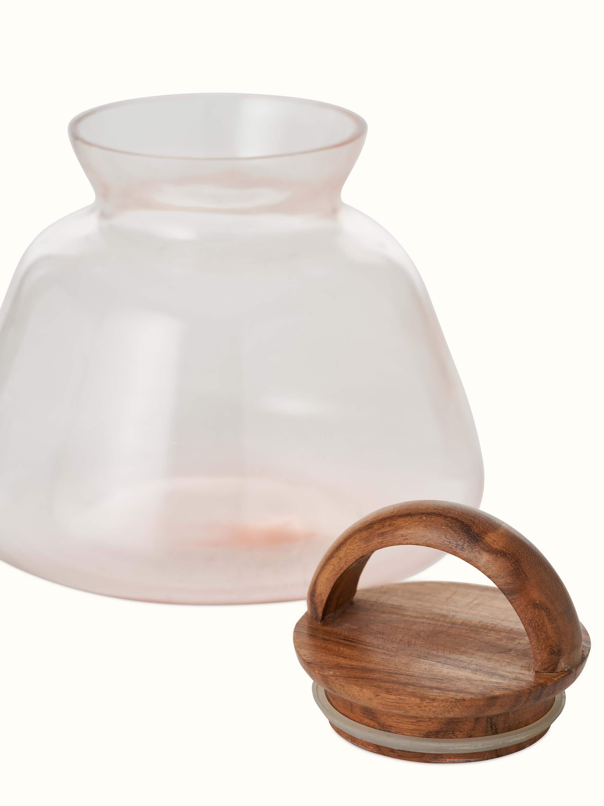 Angled view of pink glass-worked storage container highlighting its modern design and functional style