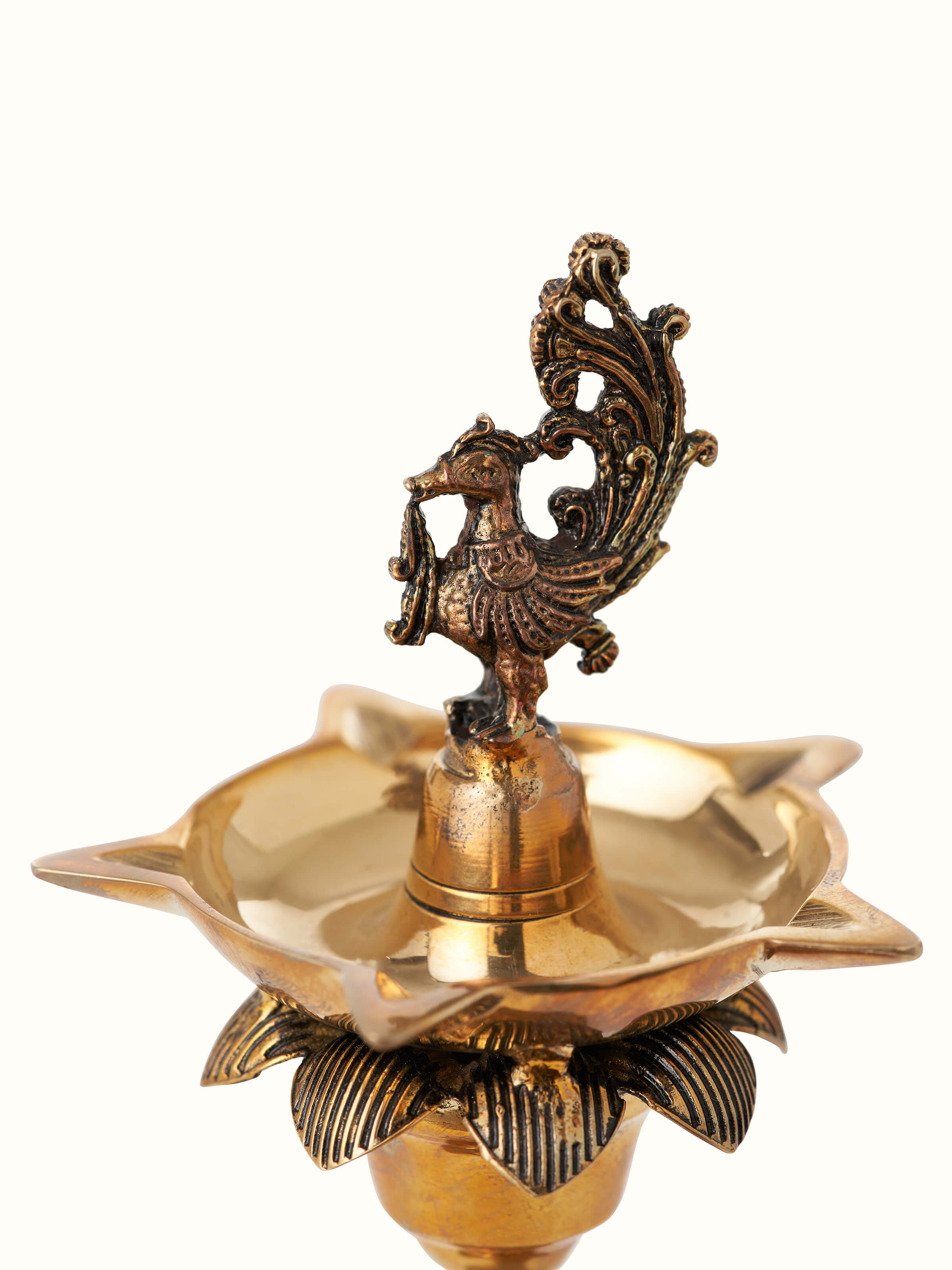 Side view of polished brass Gajanan vilakku, emphasizing the elegant design and traditional aesthetics.