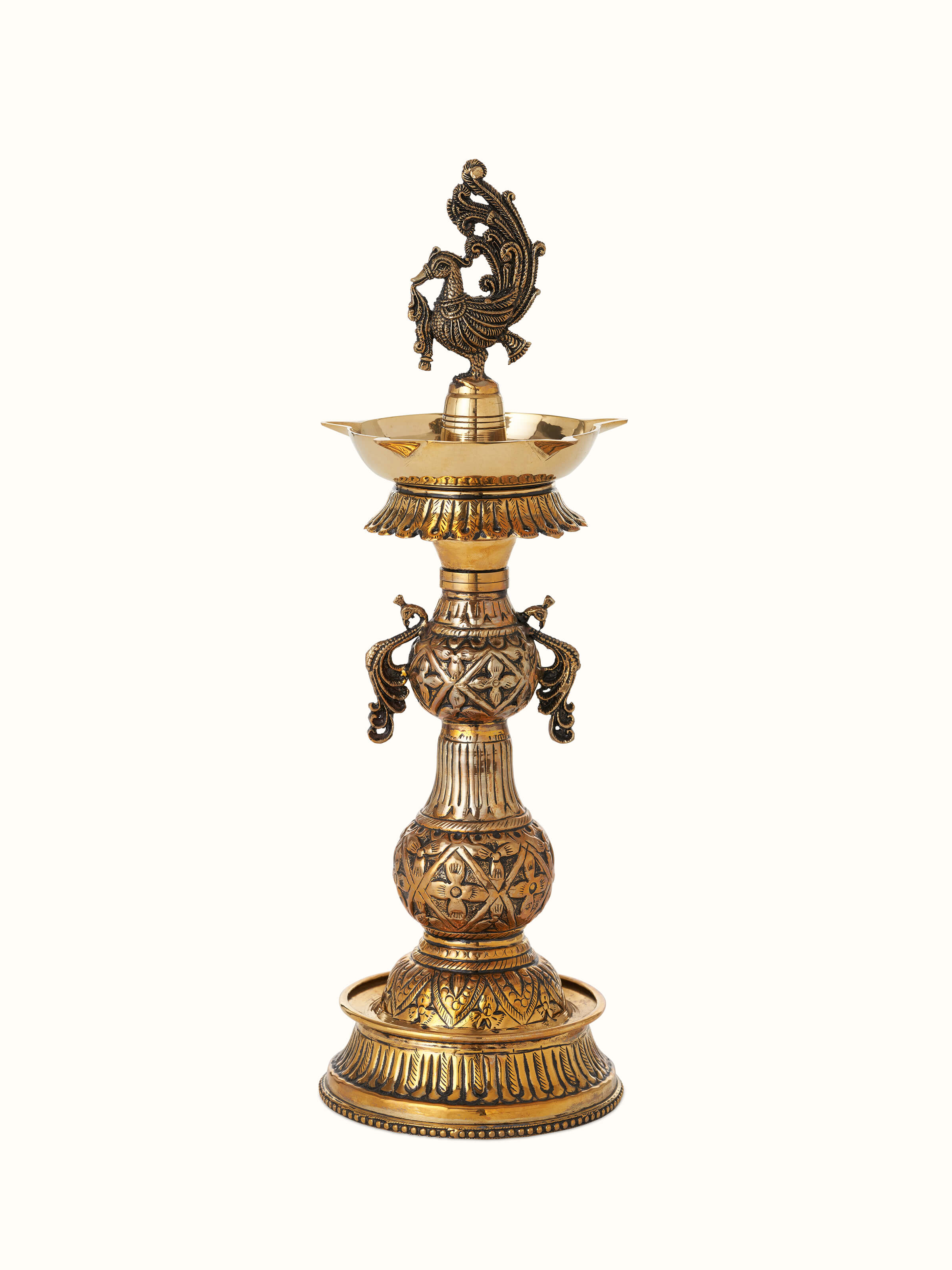 Front view of Polished brass mayur vilakku with traditional design