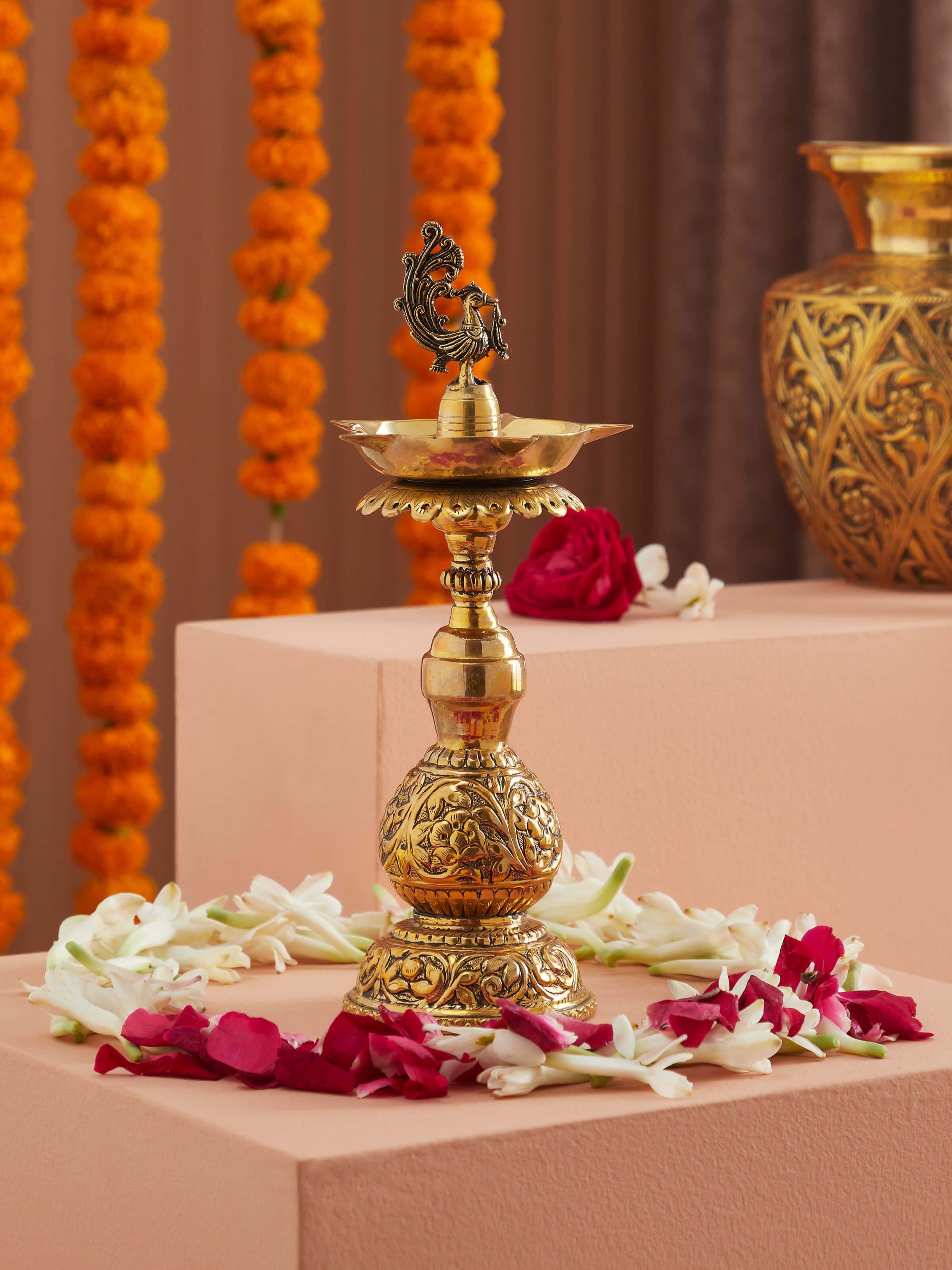 Side view of polished brass Stambh Vilakku highlighting its detailed craftsmanship and polished finish