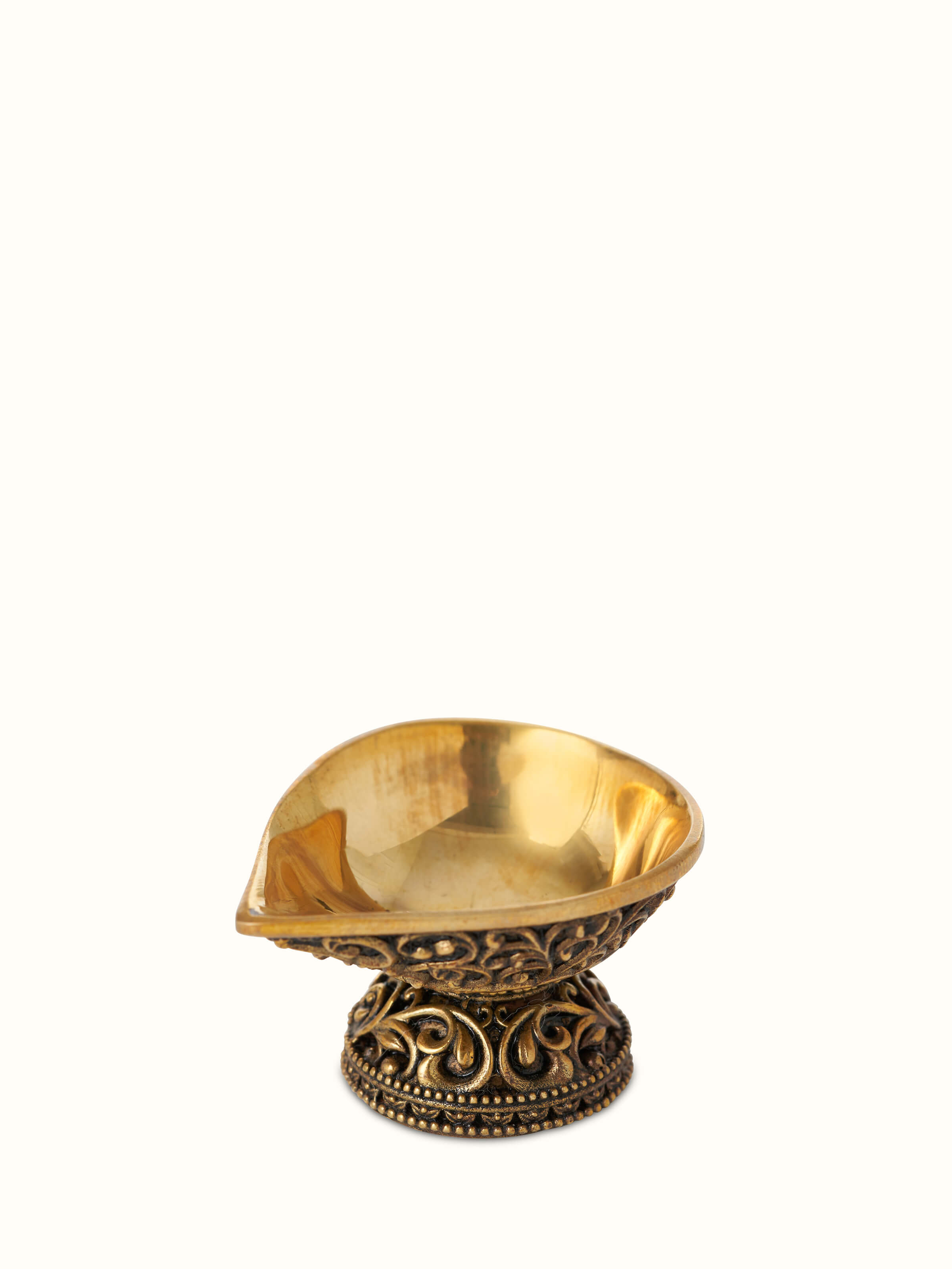Angled view of Polished brass diya small focusing on its sleek shape and decorative elements