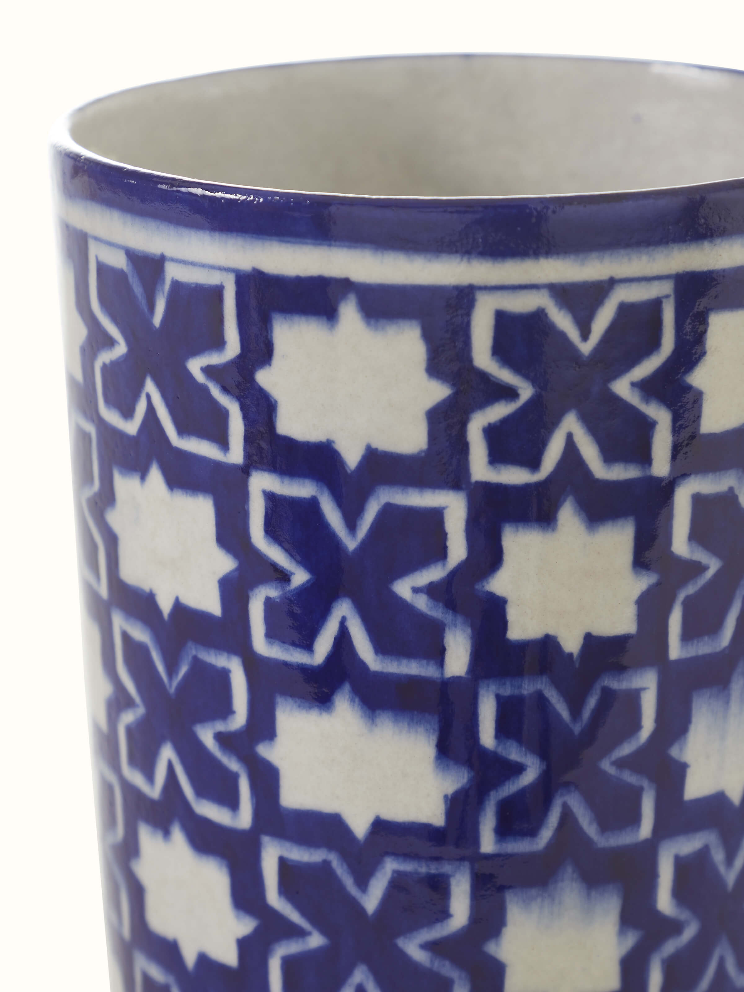 Side view of a blue pottery ceramic table vase, emphasizing its intricate blue patterns and smooth finish.