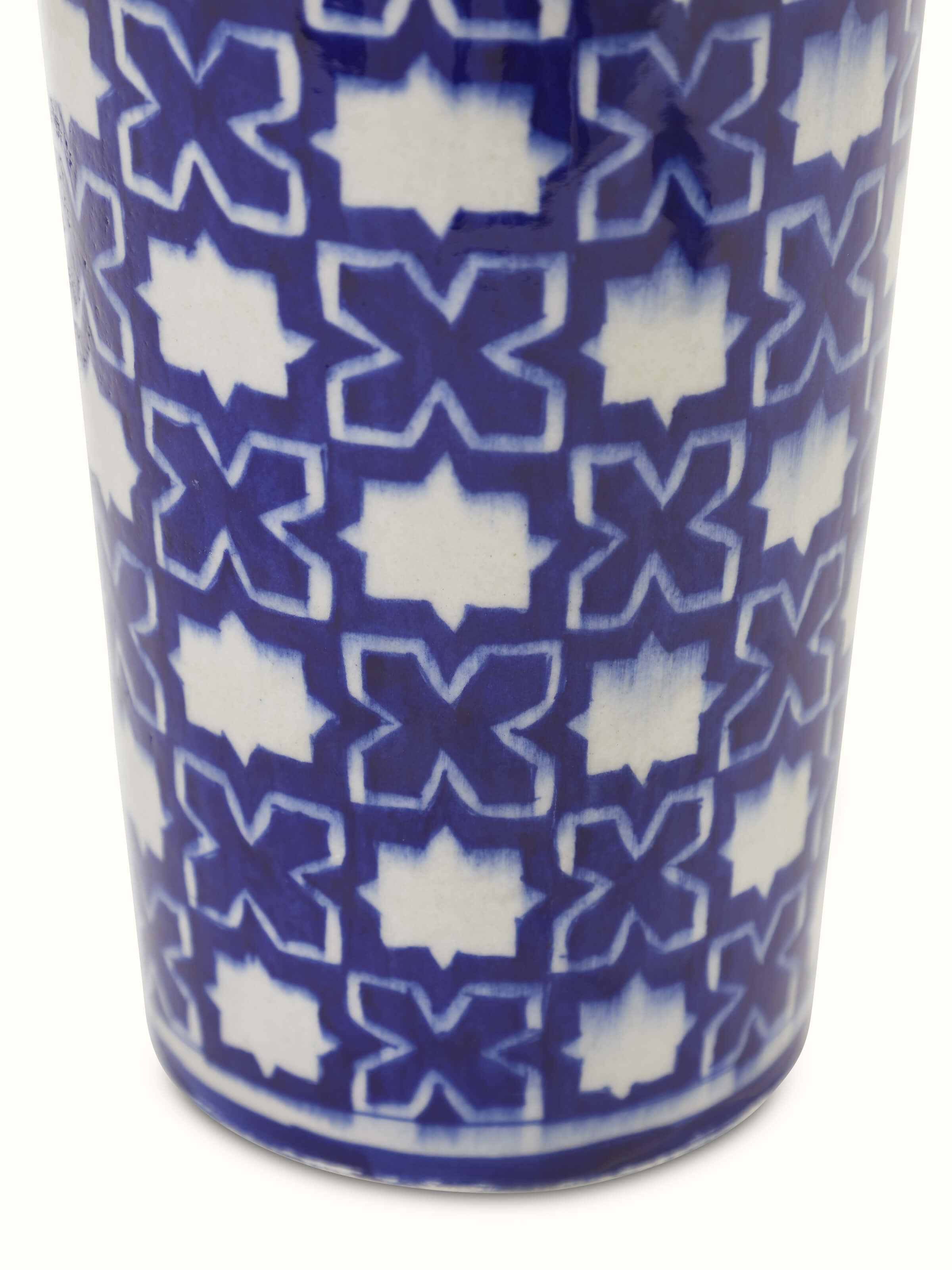 Angled view of a blue pottery ceramic table vase, showcasing its artistic design and fine details.