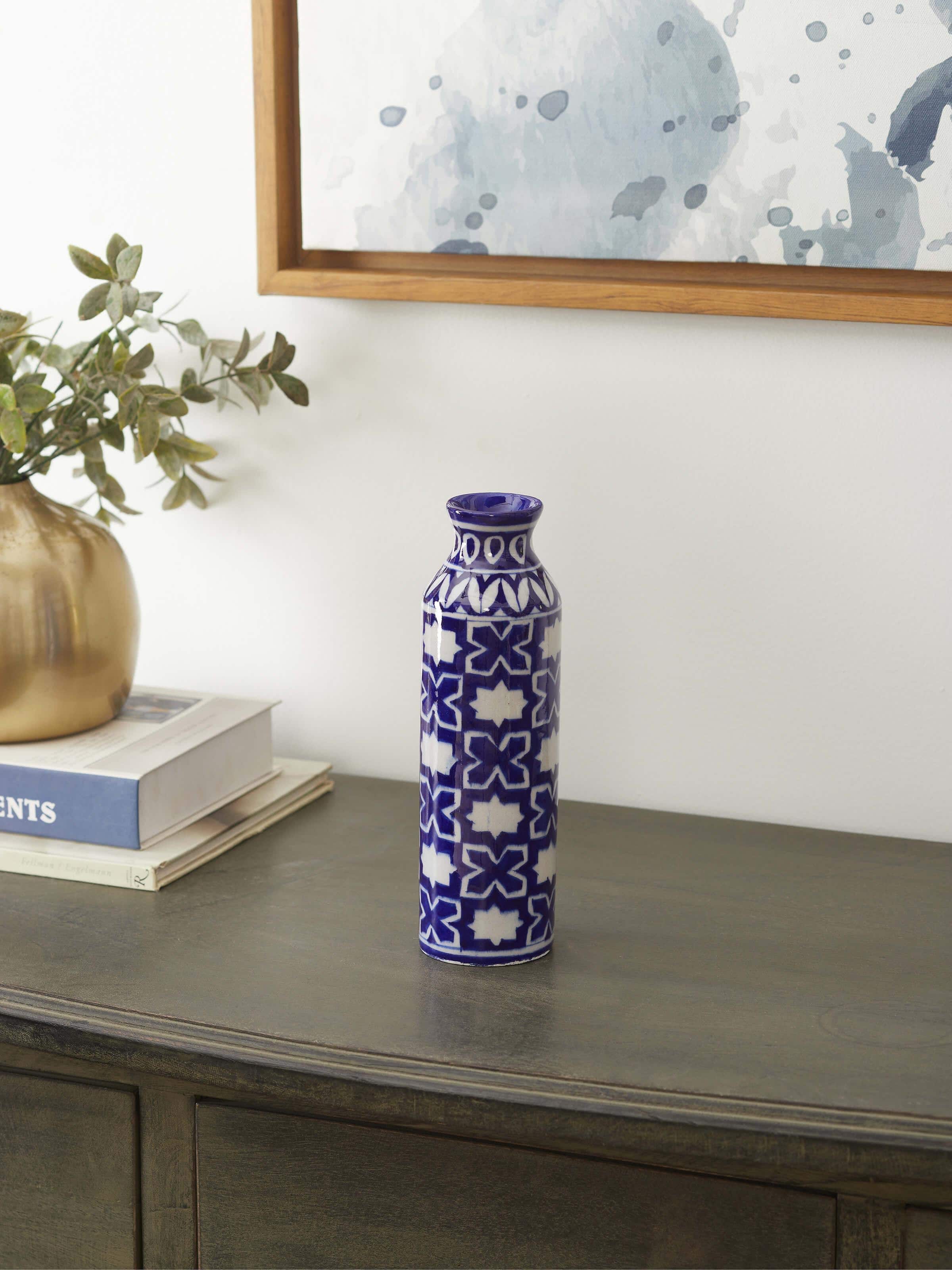 Side view of Blue pottery ceramic bud vase emphasizing the pottery’s unique design and blue color.