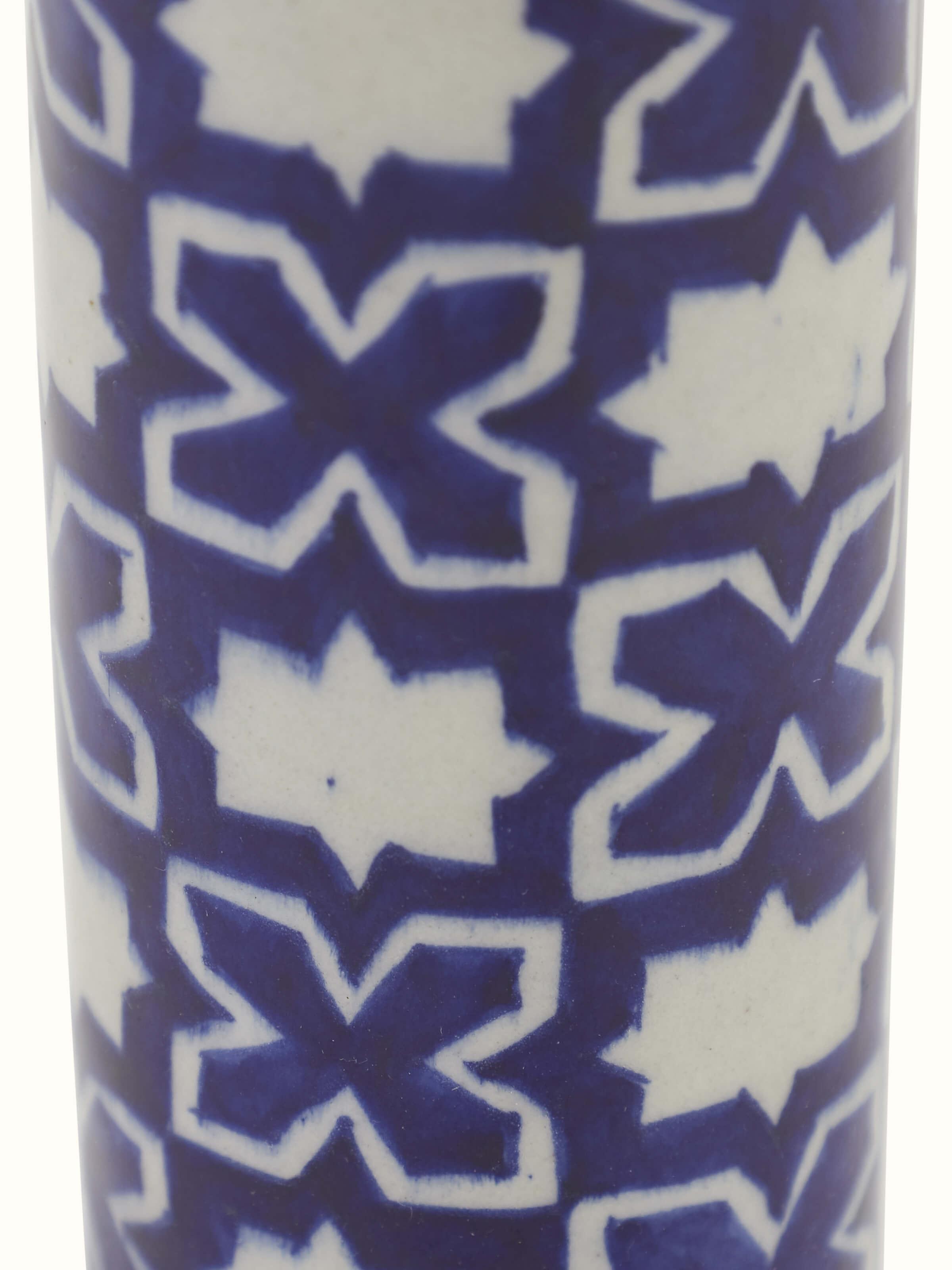 Angle view of Blue pottery ceramic bud vase showing the overall design and blue pottery glaze.