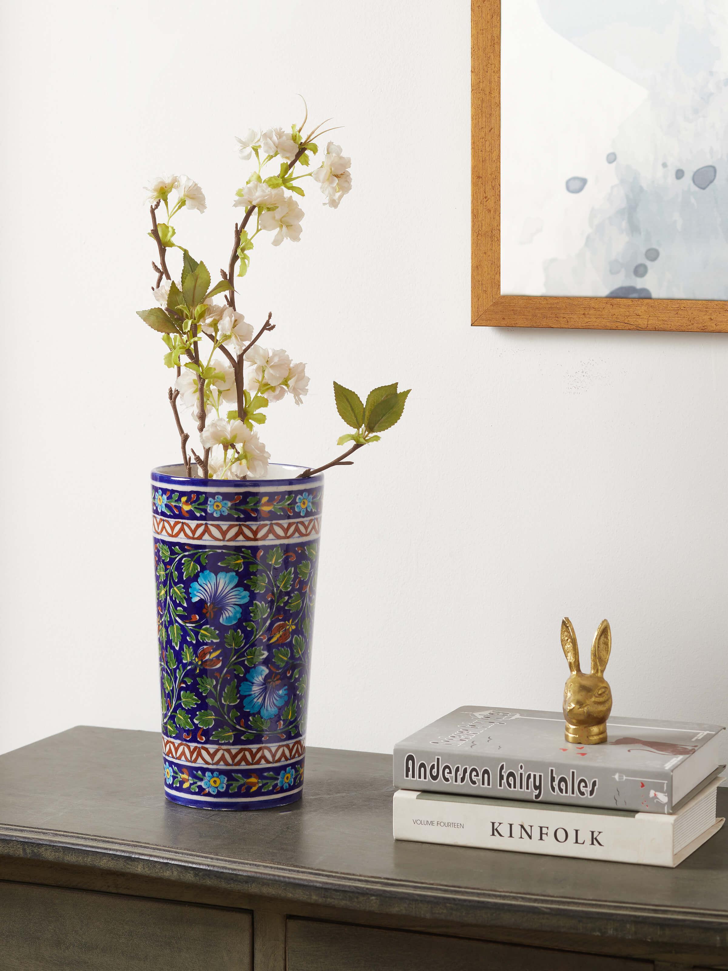 Side view of large blue pottery ceramic table vase showcasing intricate patterns and detailed craftsmanship