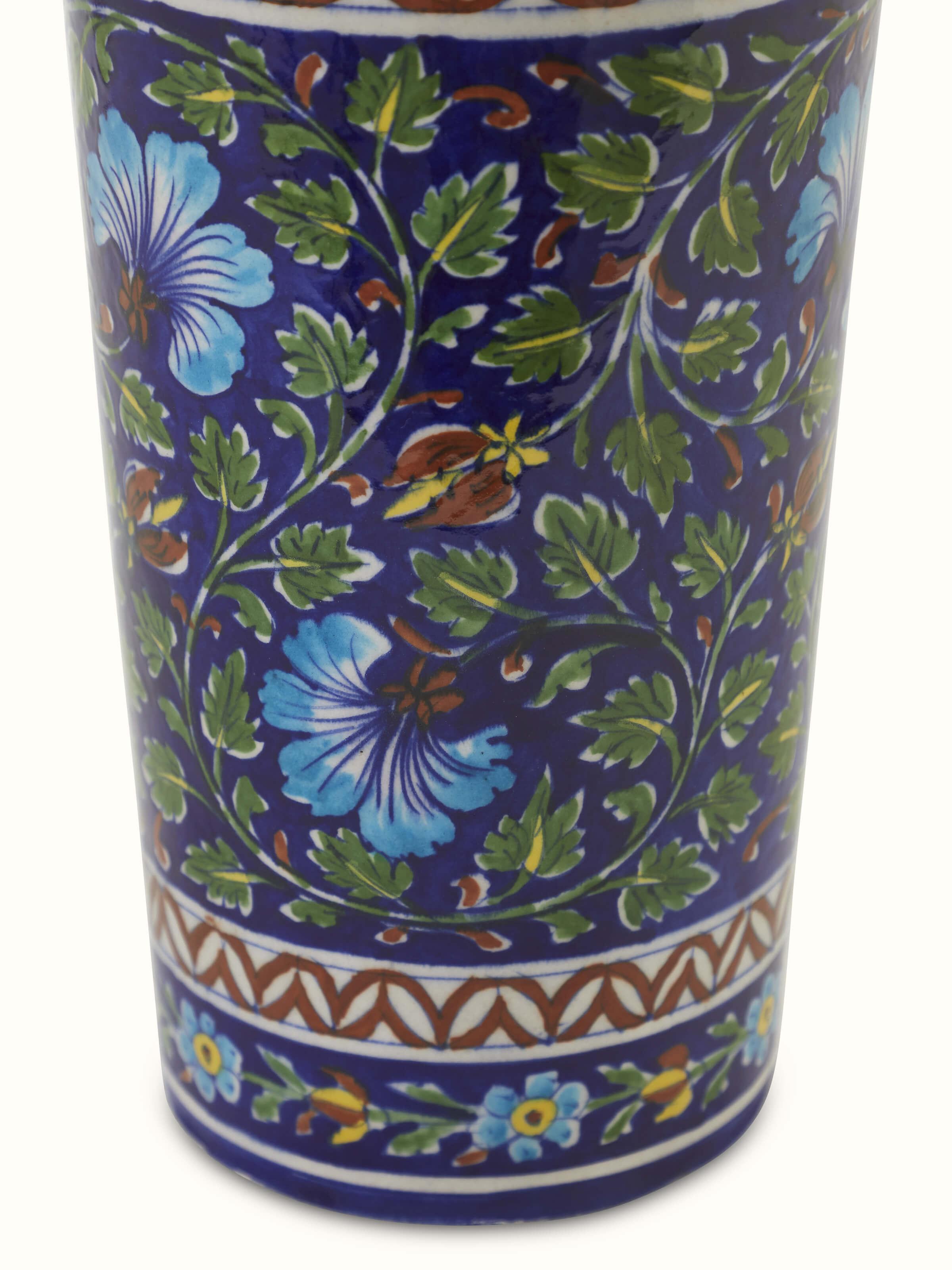 Angled view of large blue pottery ceramic table vase emphasizing its unique shape and decorative details
