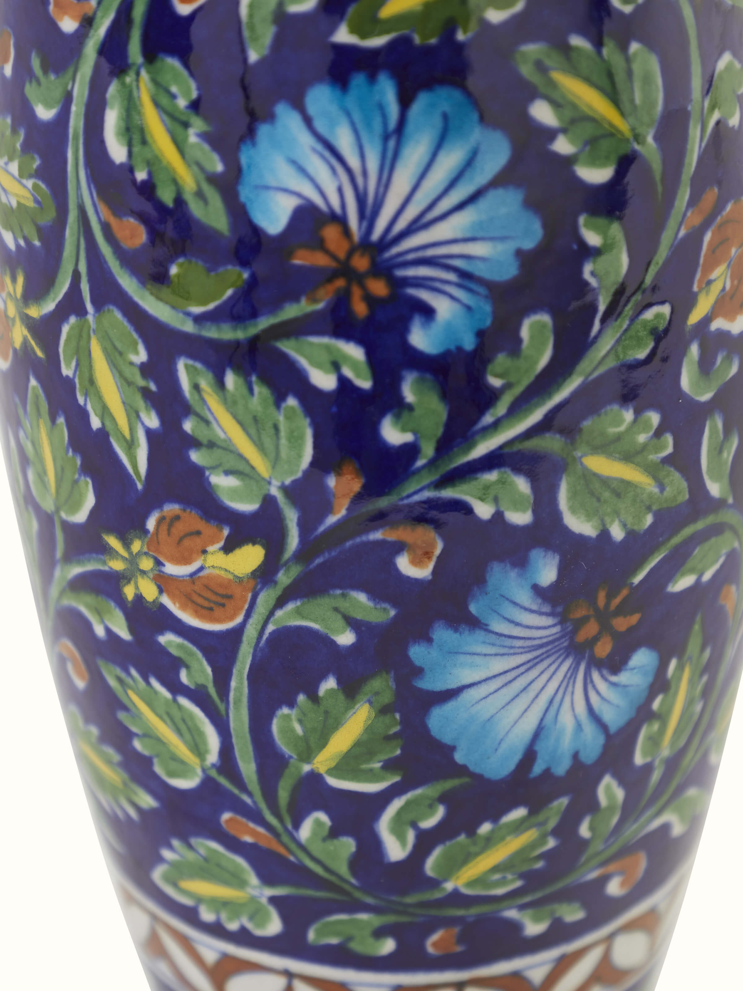 Angled view of Glossy blue pottery ceramic table vase emphasizing the glossy finish and artistic design