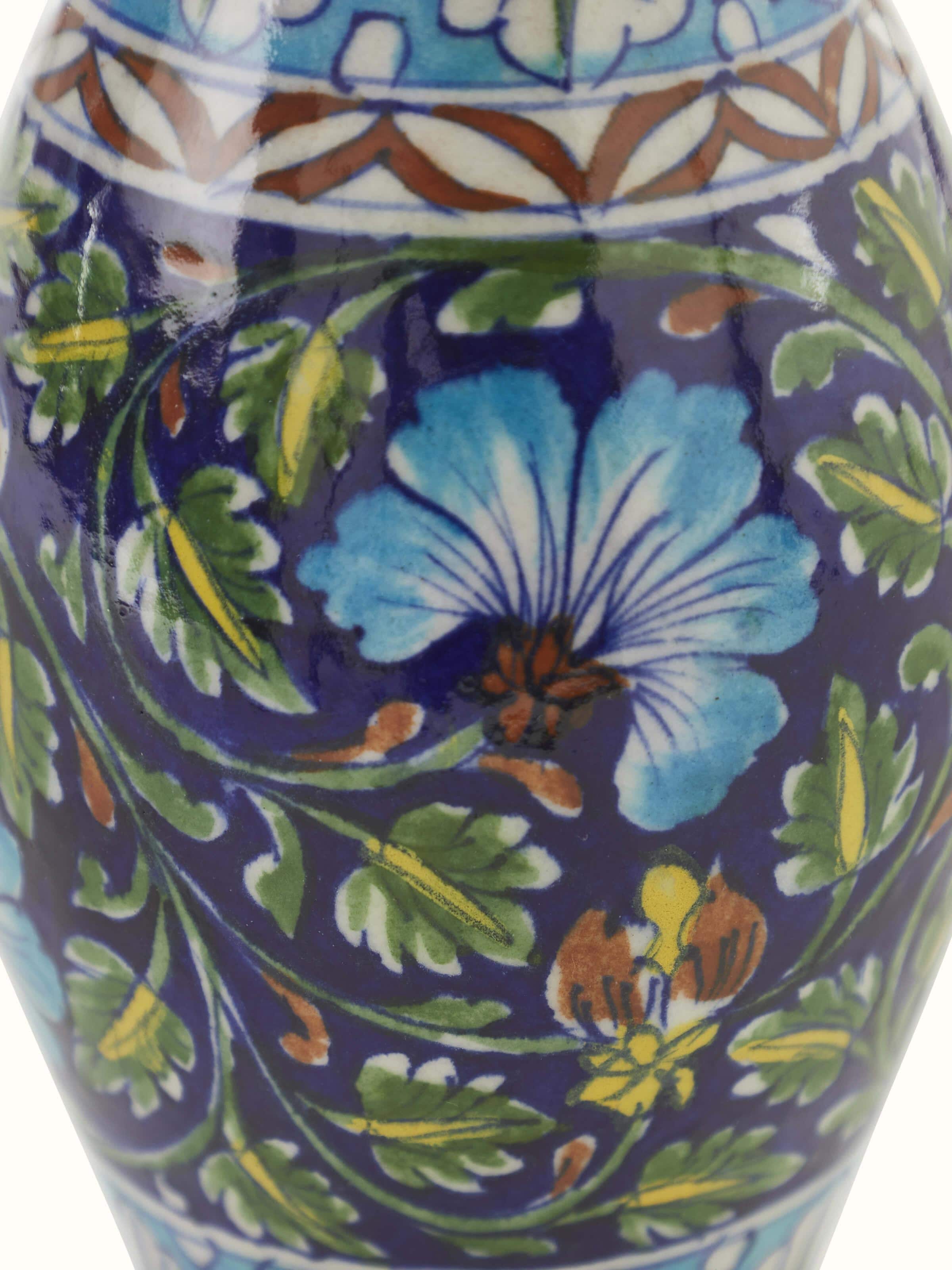 Angled view of Natural Blue Pottery Ceramic Bud Vase, focusing on the intricate patterns and details