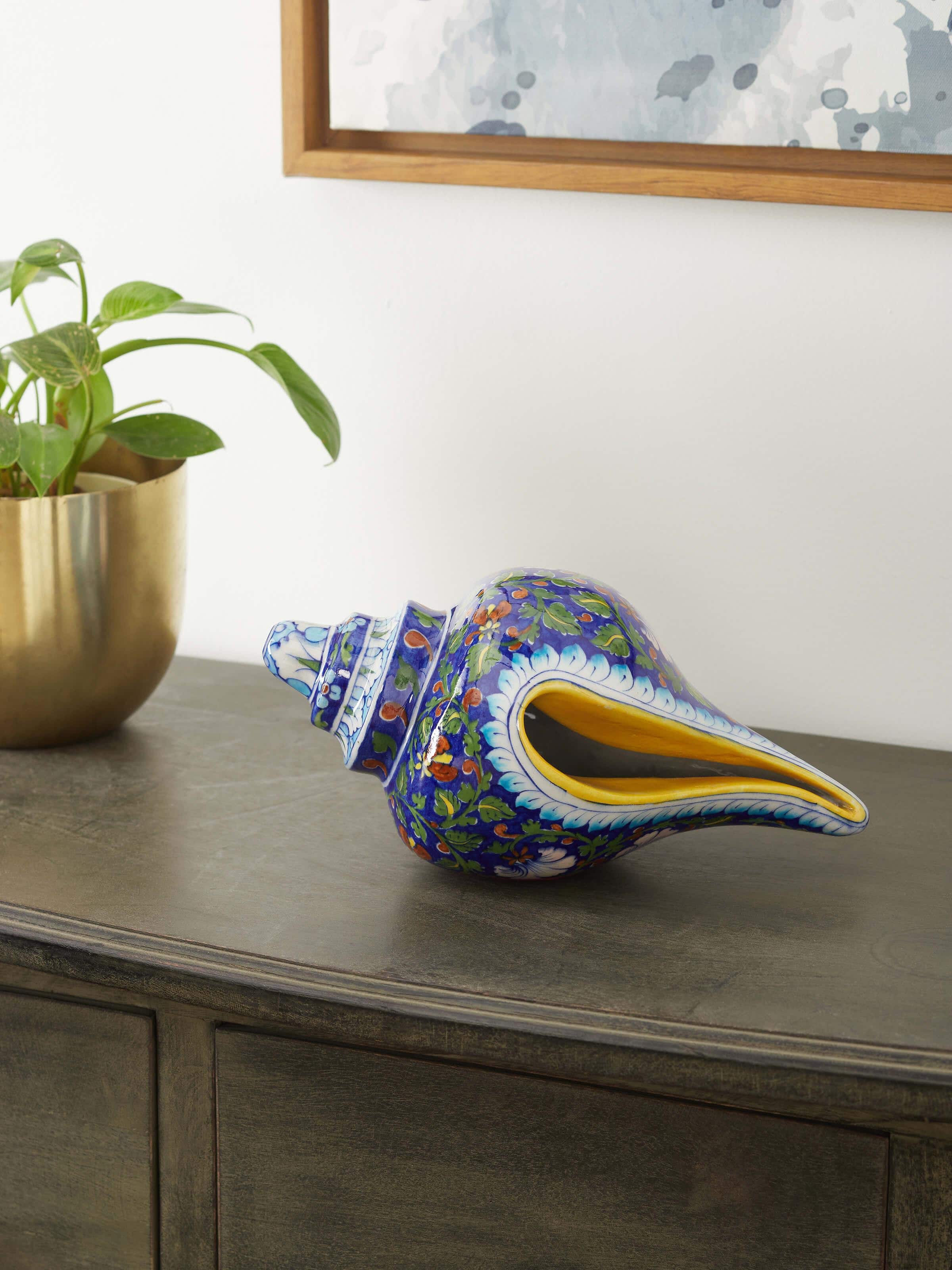 Side view of Blue pottery ceramic garden shell artpiece showcasing detailed pottery work and artistic shape