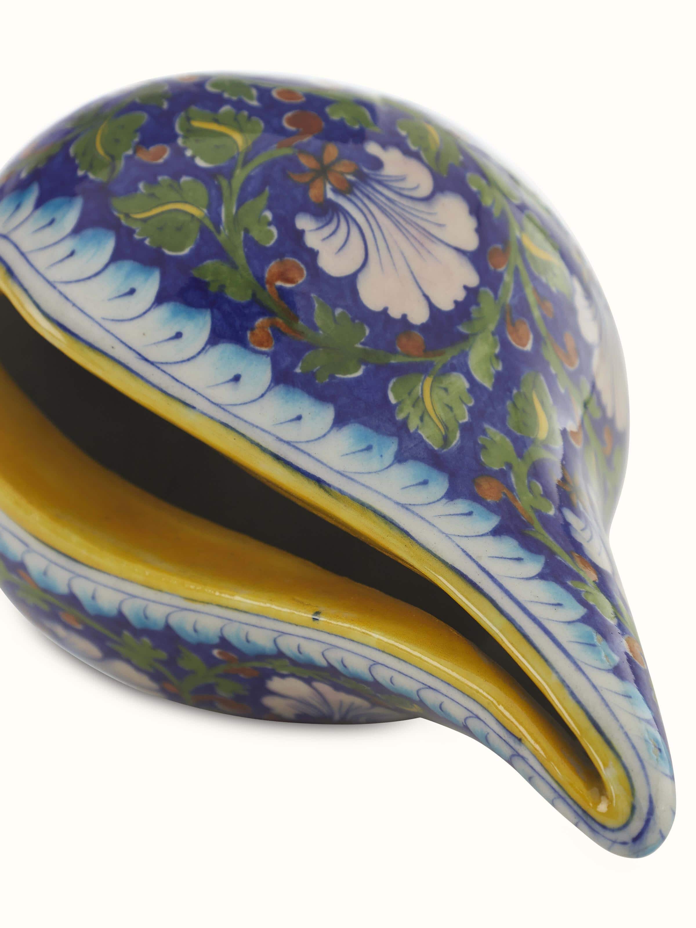 Detailed view of Blue pottery ceramic garden shell artpiece focusing on the fine craftsmanship and elegant design