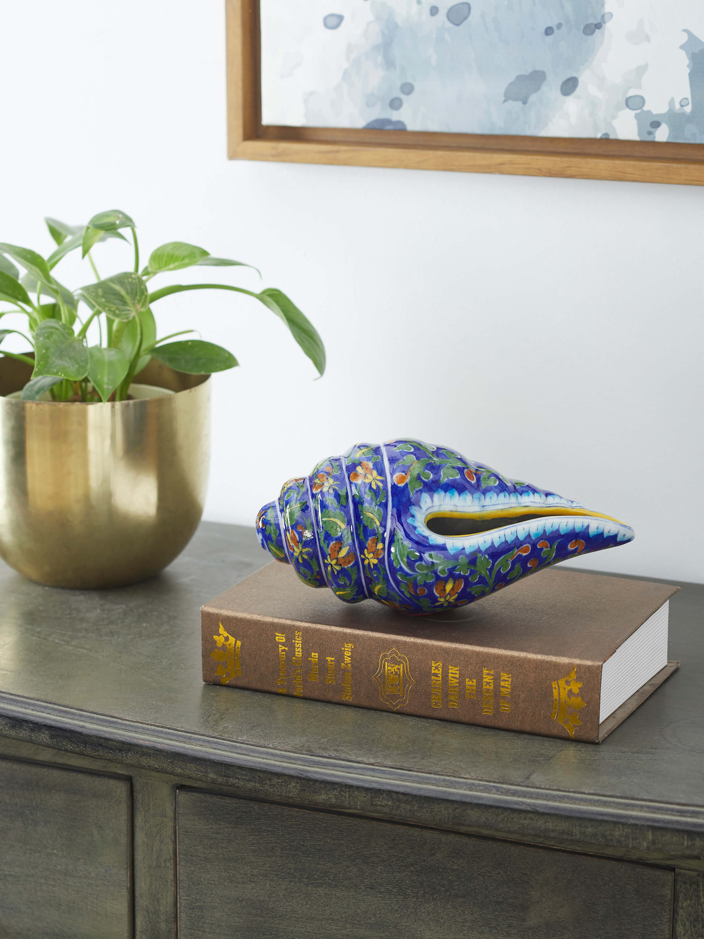 Side view of Blue pottery ceramic garden shell artpiece in indigo color highlighting detailed shell design.