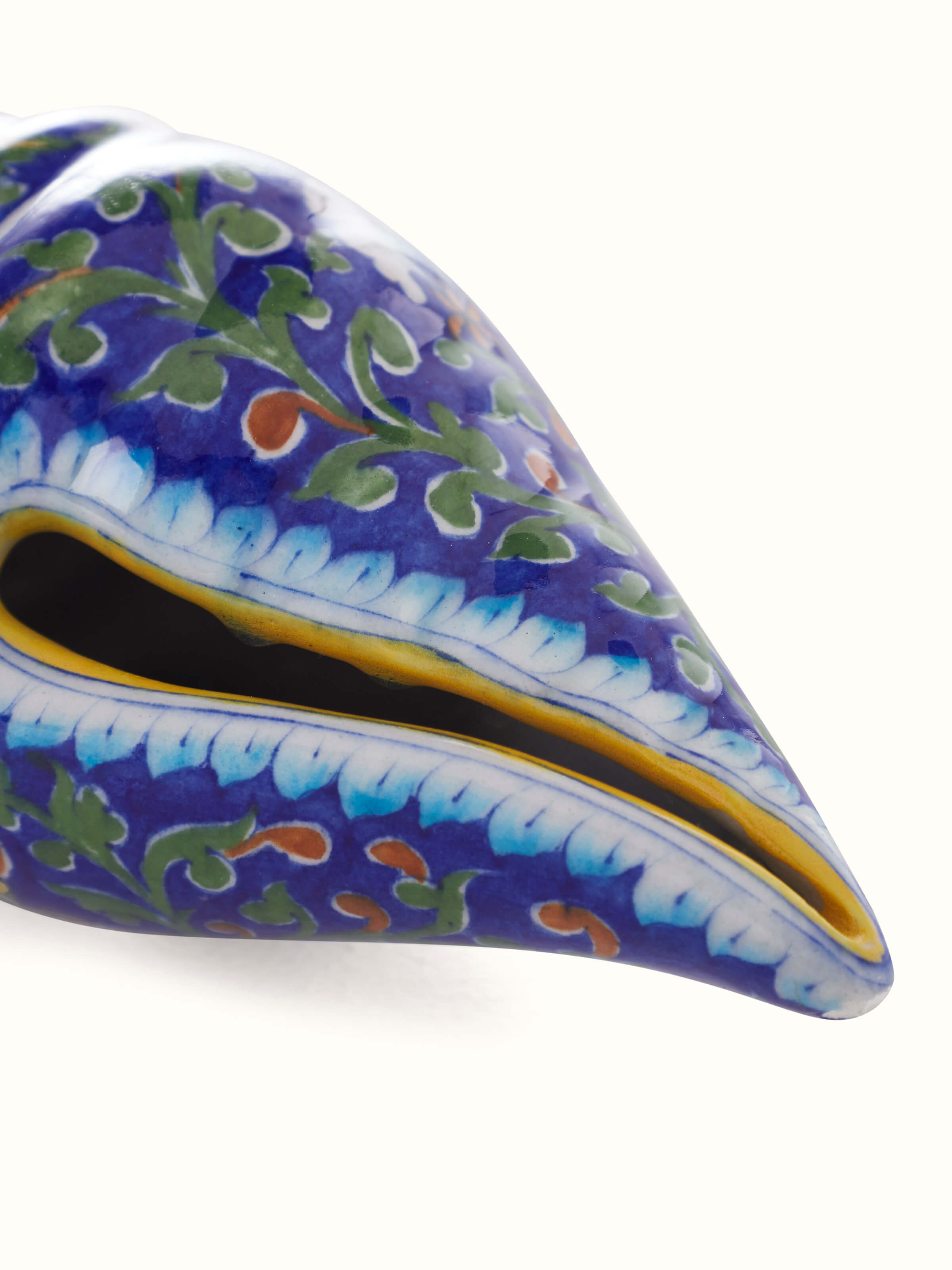 Detailed view of Blue pottery ceramic garden shell artpiece in indigo color focusing on ceramic texture.