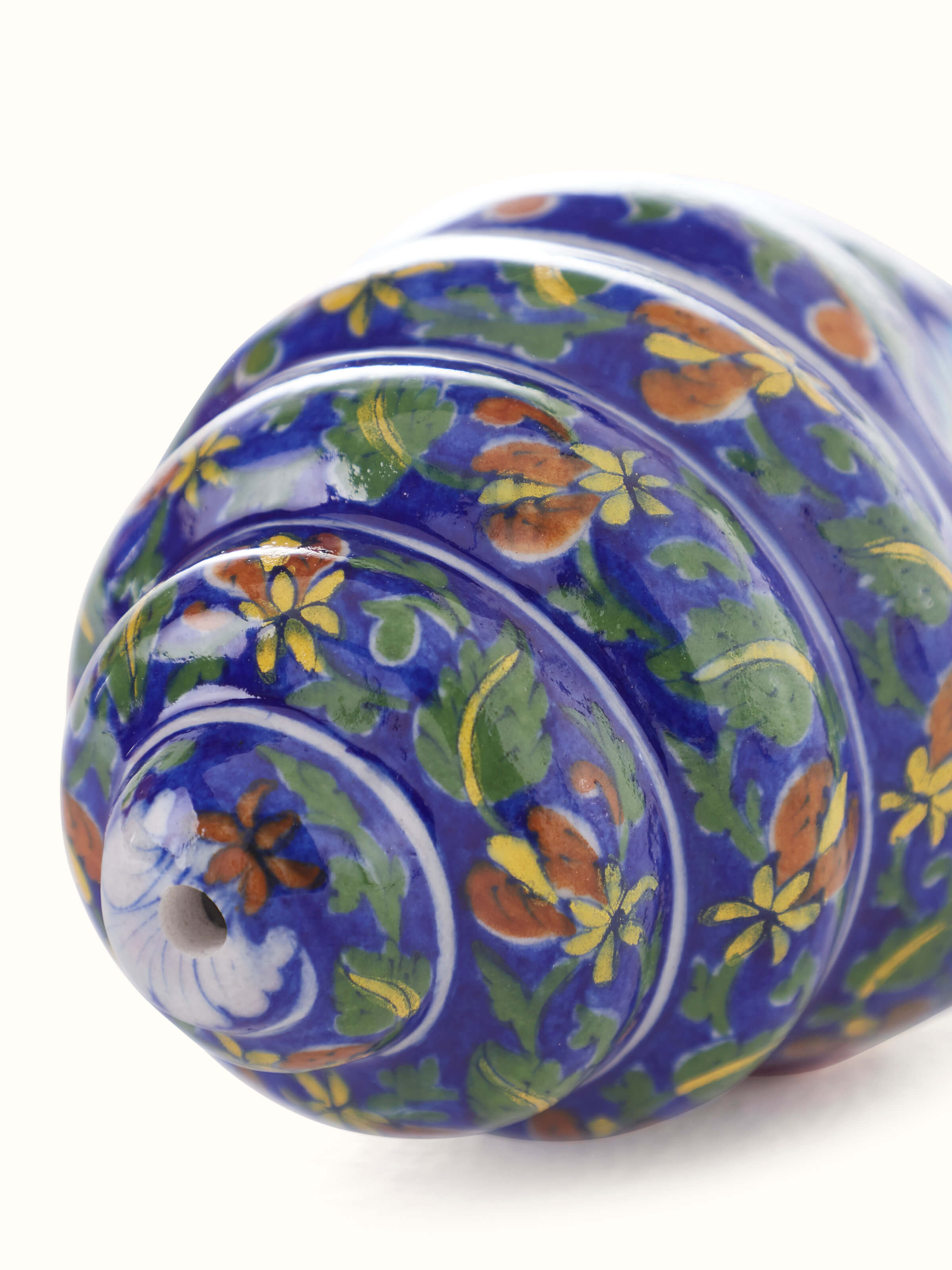 Close-up of Blue pottery ceramic garden shell artpiece in indigo color showcasing intricate patterns.