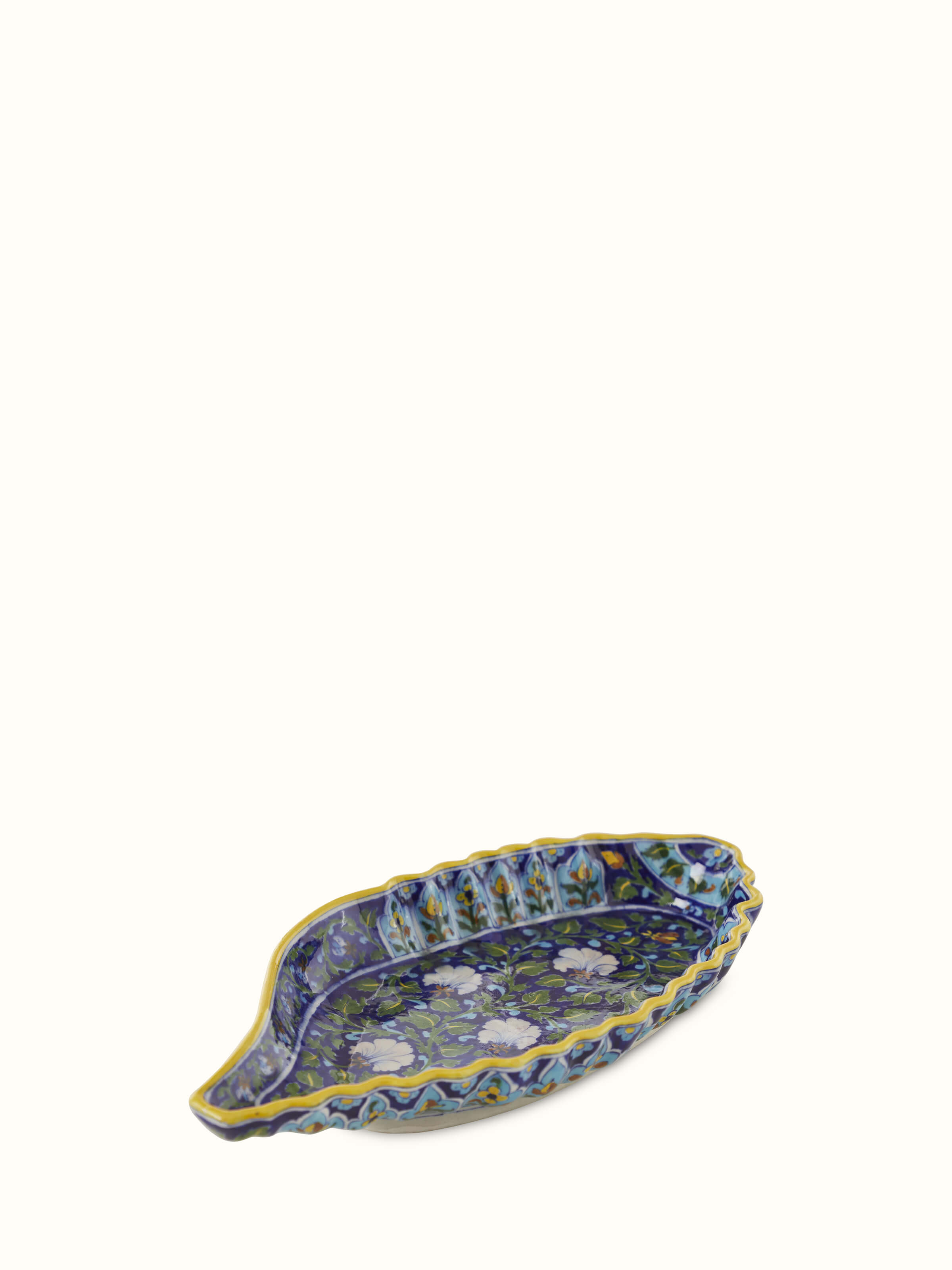 Angled view of blue pottery ceramic conch shell planter, displaying its artistic shape and vibrant glaze.