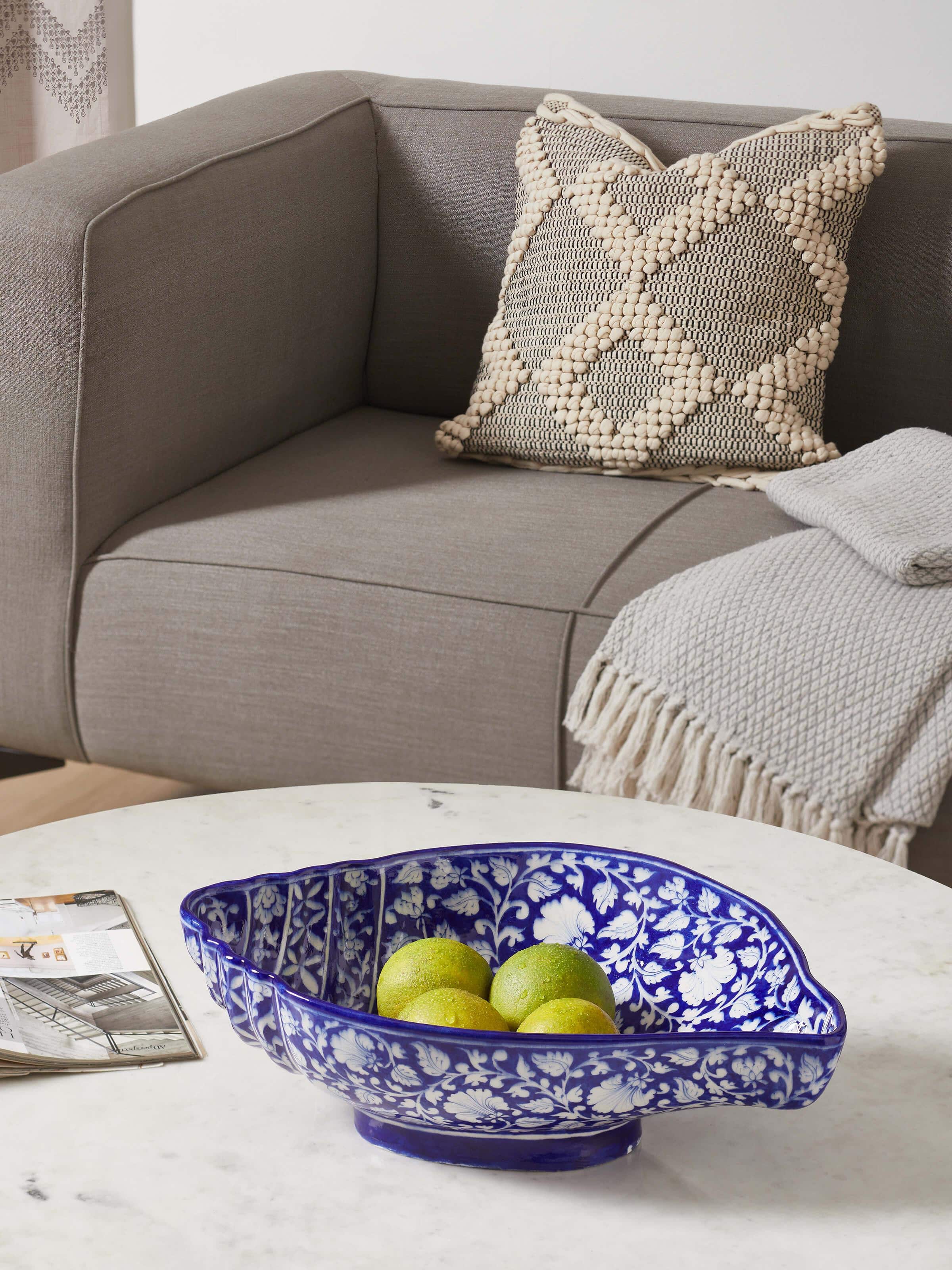 Side view of Glossy blue pottery ceramic conch shell planter showcasing detailed shell design.