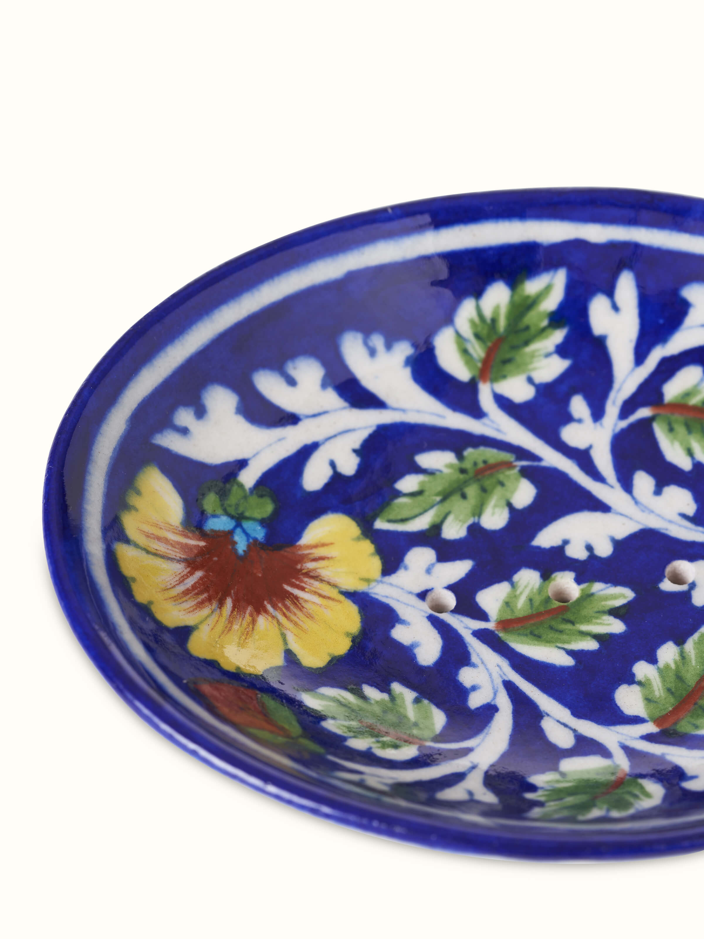 Close-up of blue pottery ceramic soap dish focusing on the intricate design and texture