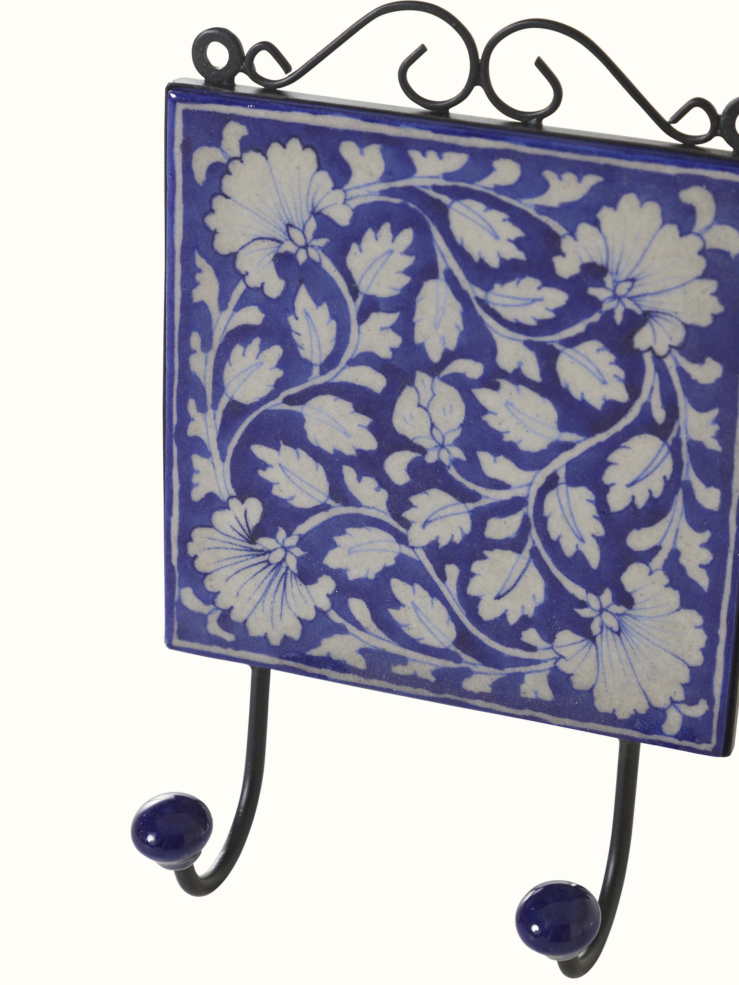 Close-up of blue pottery ceramic 2-pin wall hook highlighting fine details