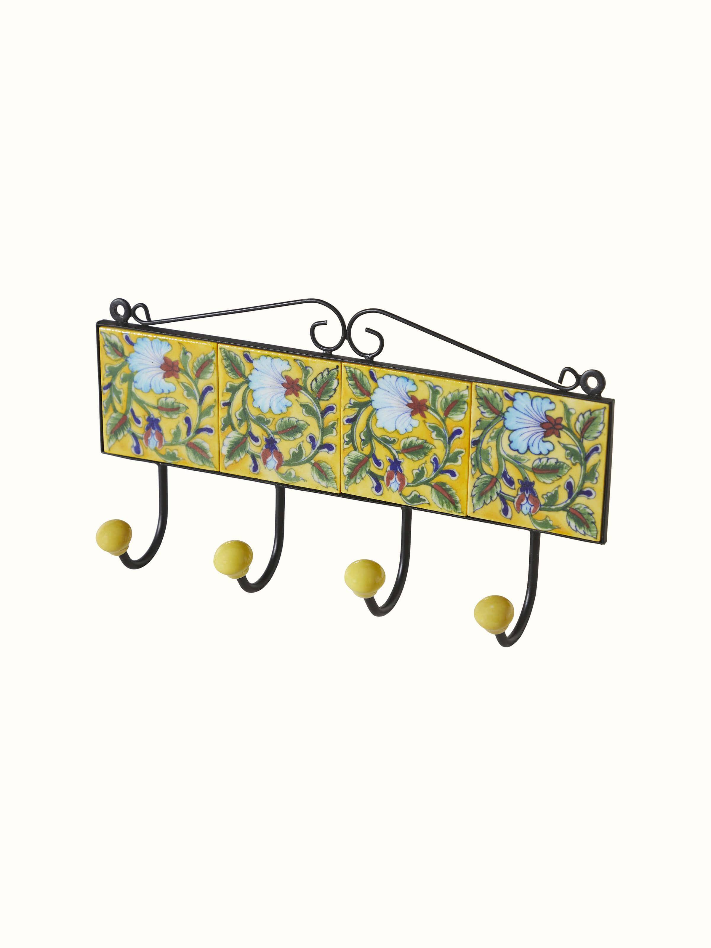 Detailed close-up of blue pottery ceramic 4-pin wall hook in yellow, emphasizing the intricate design and finish.