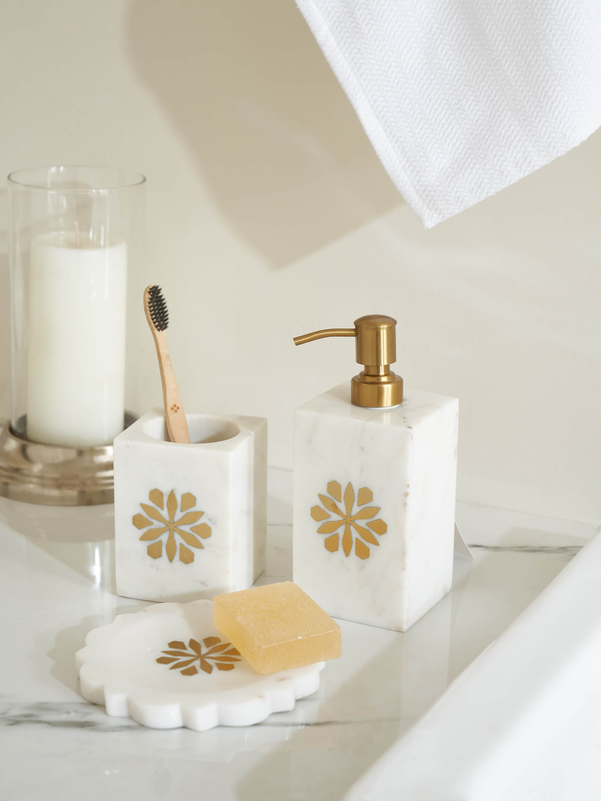 Side angle of the marble and brass toothbrush holder, emphasizing the sleek design and high-quality materials.