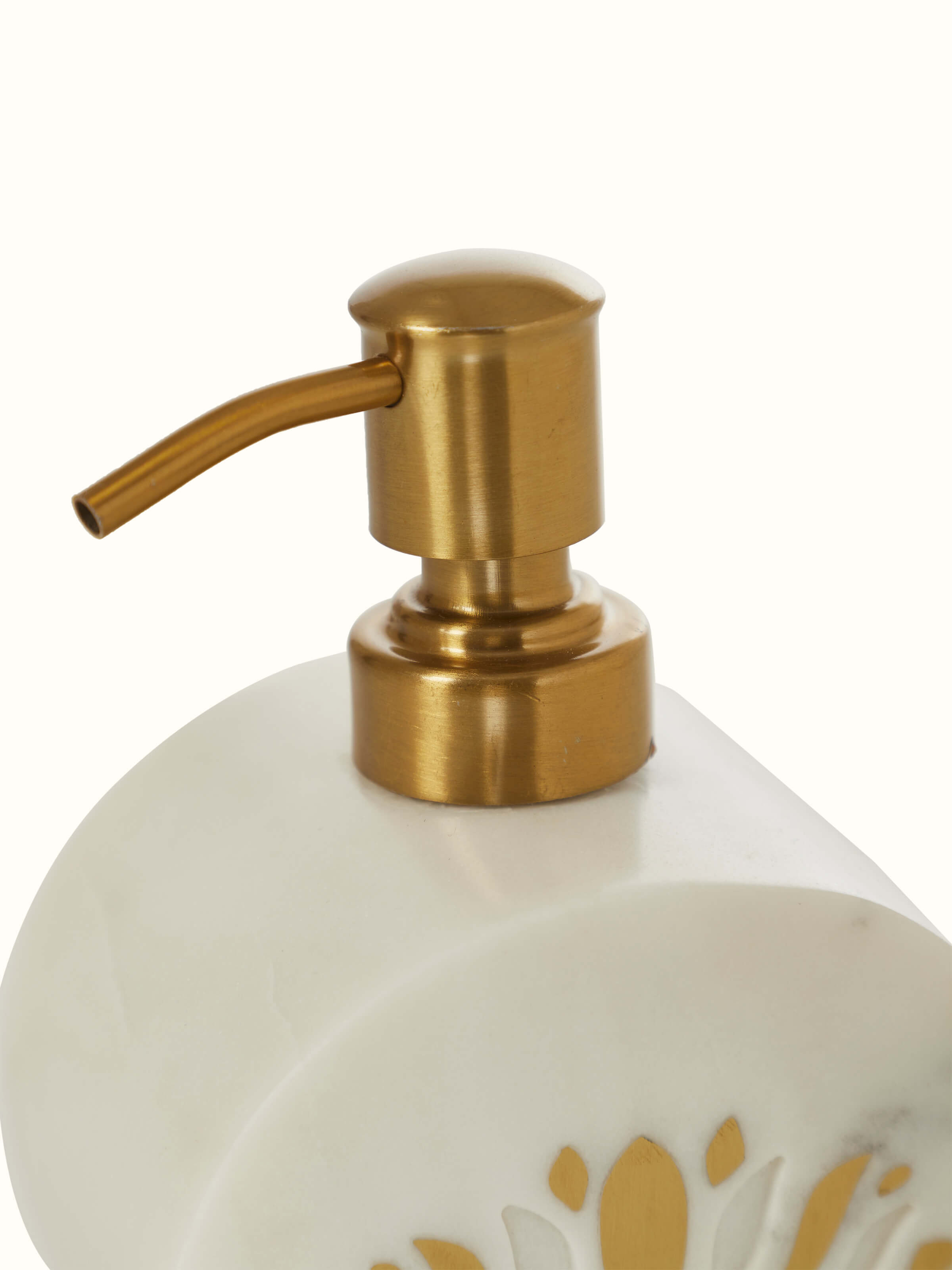 Detailed view of stone-worked marble and brass soap dispenser in gold color highlighting its elegant finish.