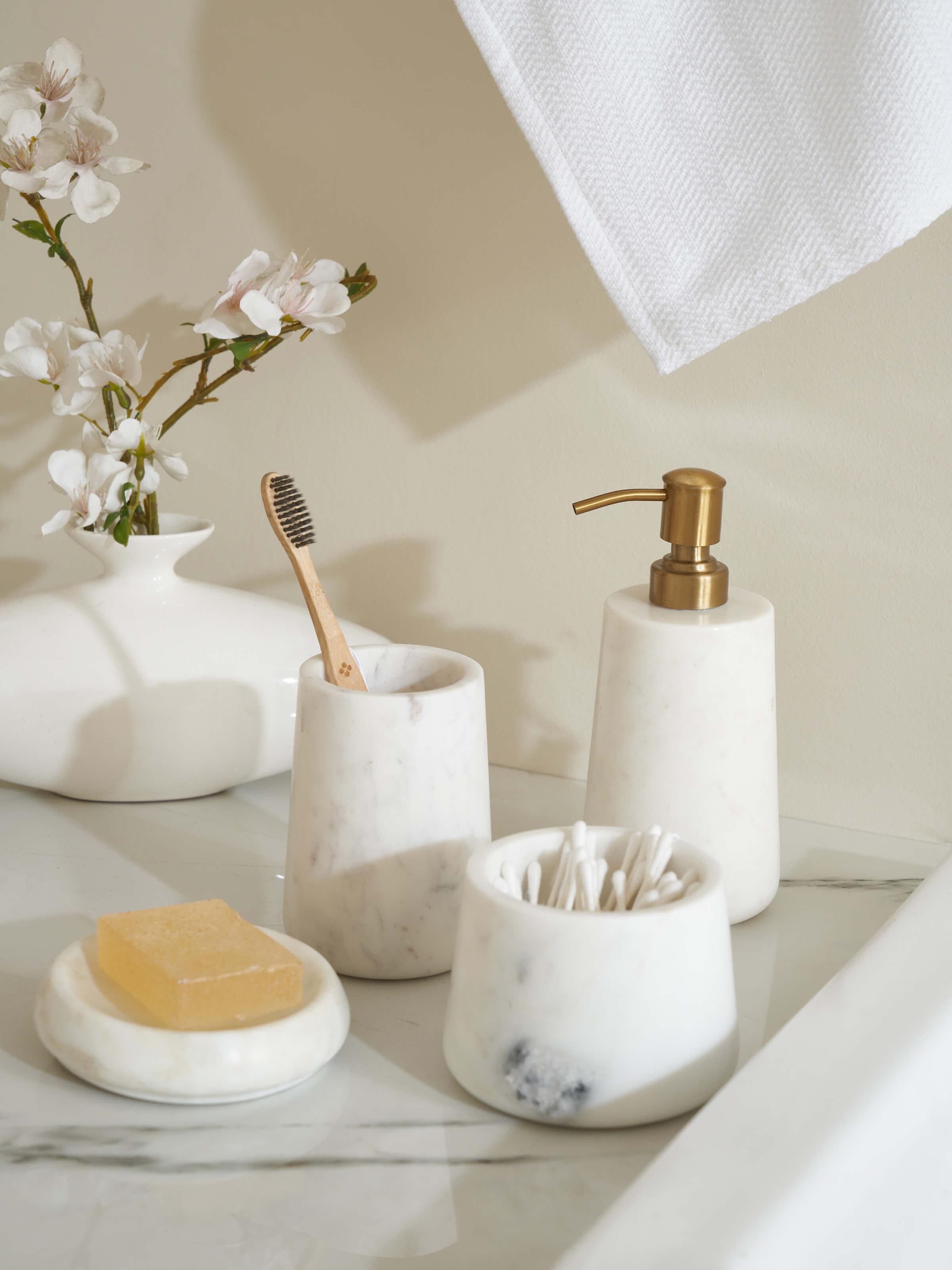 Side view of Stone-worked marble & brass soap dispenser in white color highlighting its luxurious appearance.