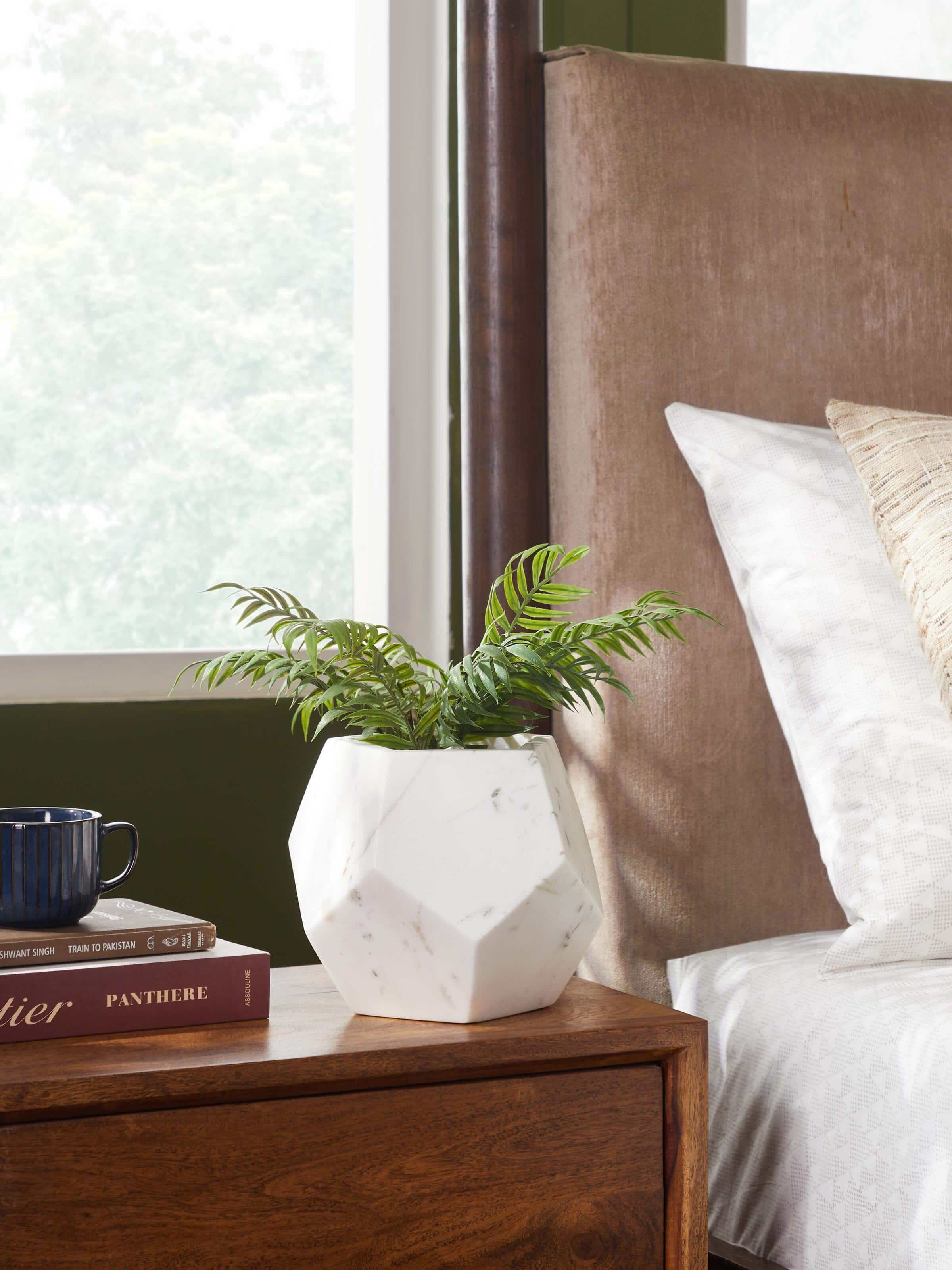 Side view of Stone-worked dodeca white marble planter showcasing the unique dodecahedron shape and marble texture