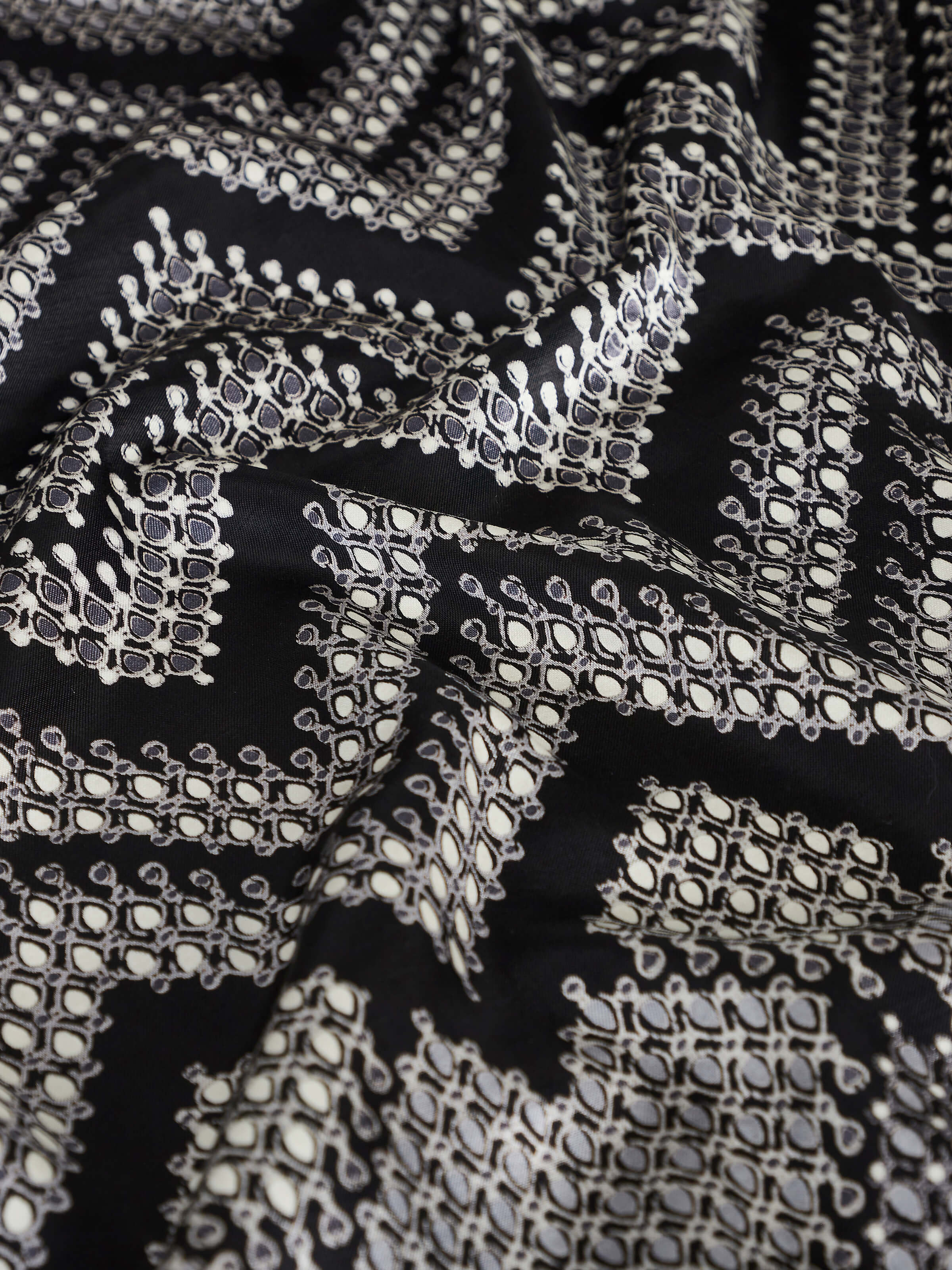 Rambagh geometric viscose cotton blend Sanganeri block printed double bedspread set, draped over a bed with matching pillow covers.