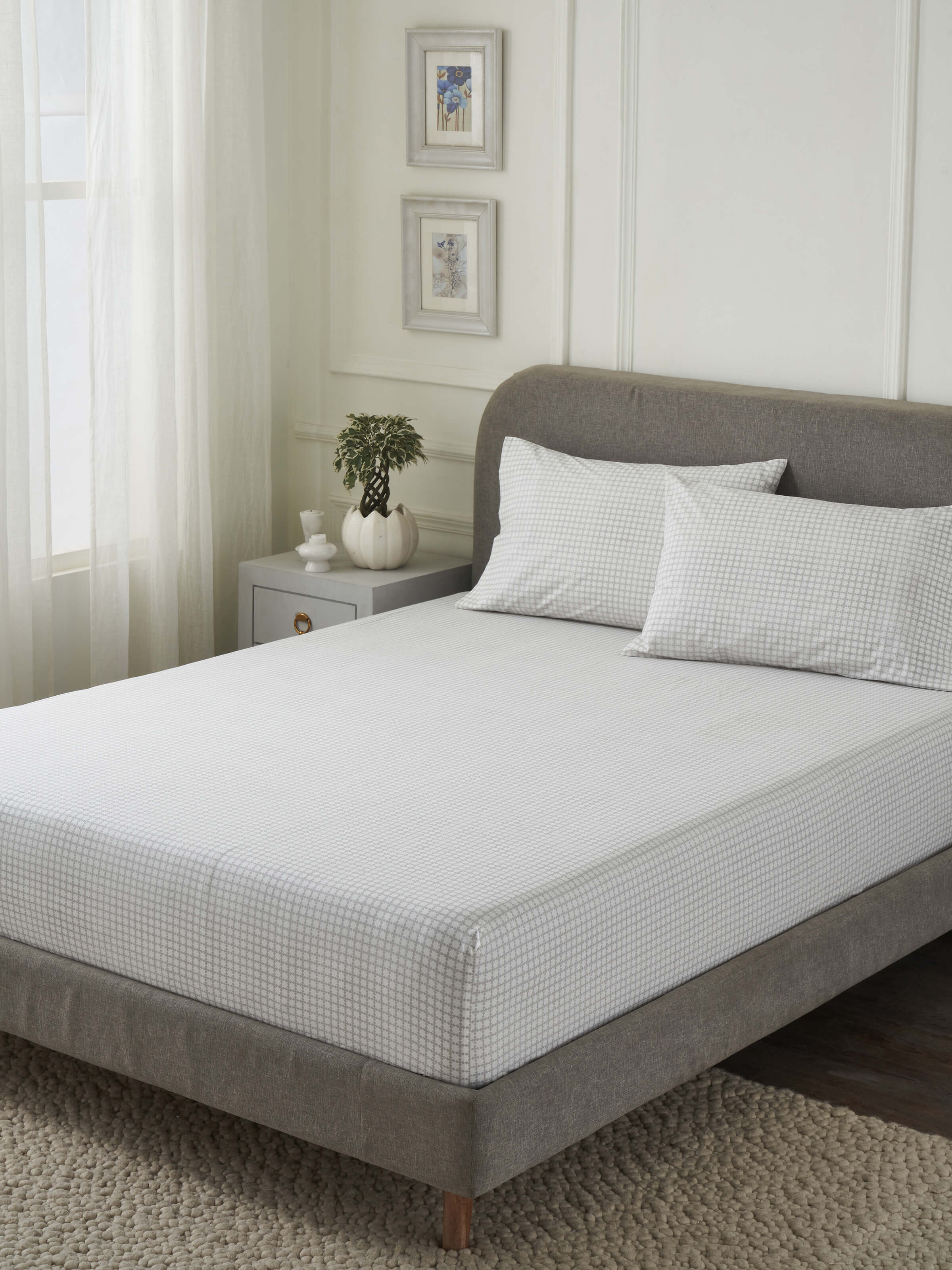 Close-up of the Pratidin grey grid cotton king fitted bedsheet set, highlighting the Sanganeri block print and soft texture