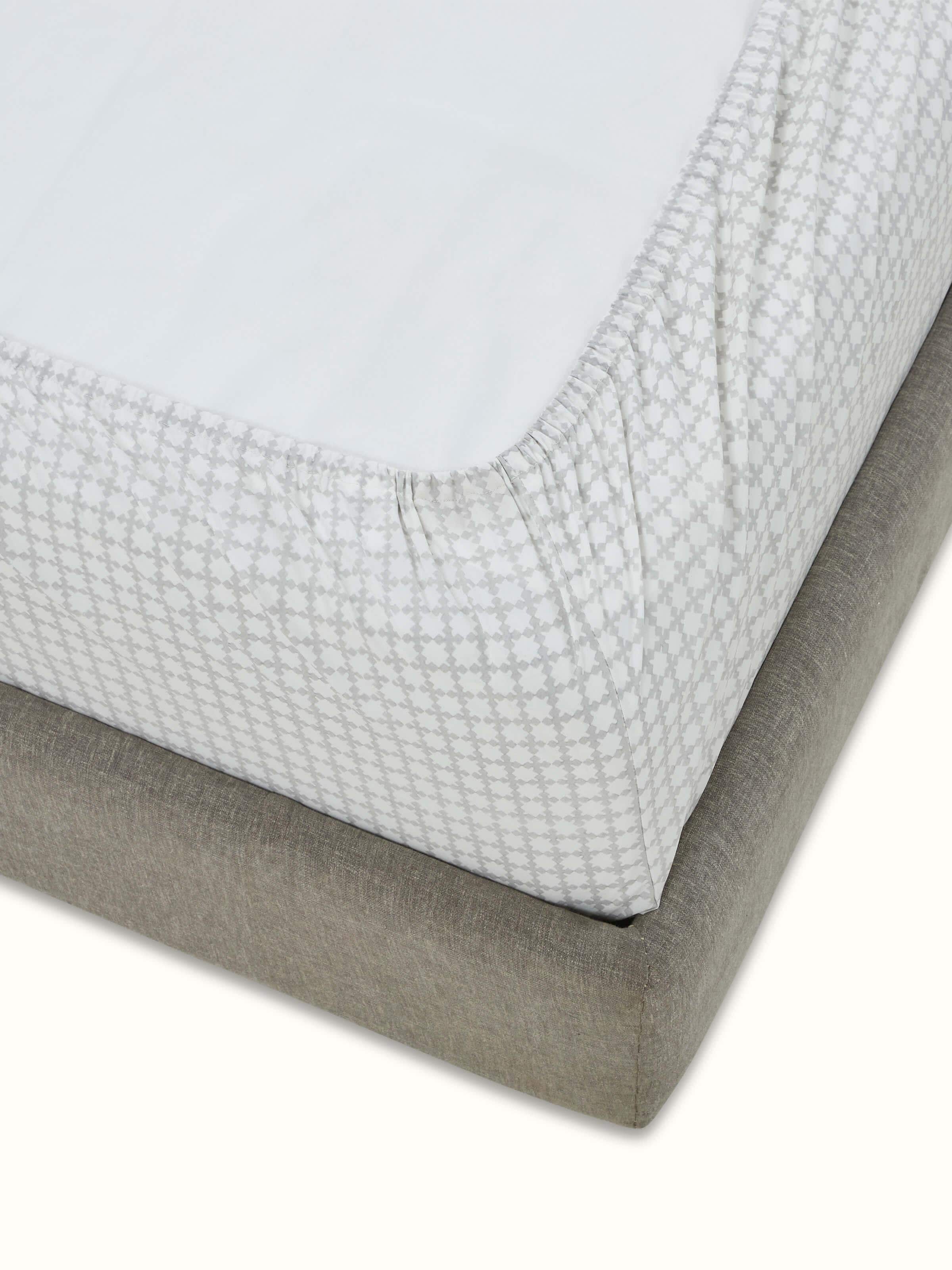 Side view of Pratidin grey grid cotton Sanganeri block printed queen fitted bedsheet set highlighting the fabric texture and grid pattern.