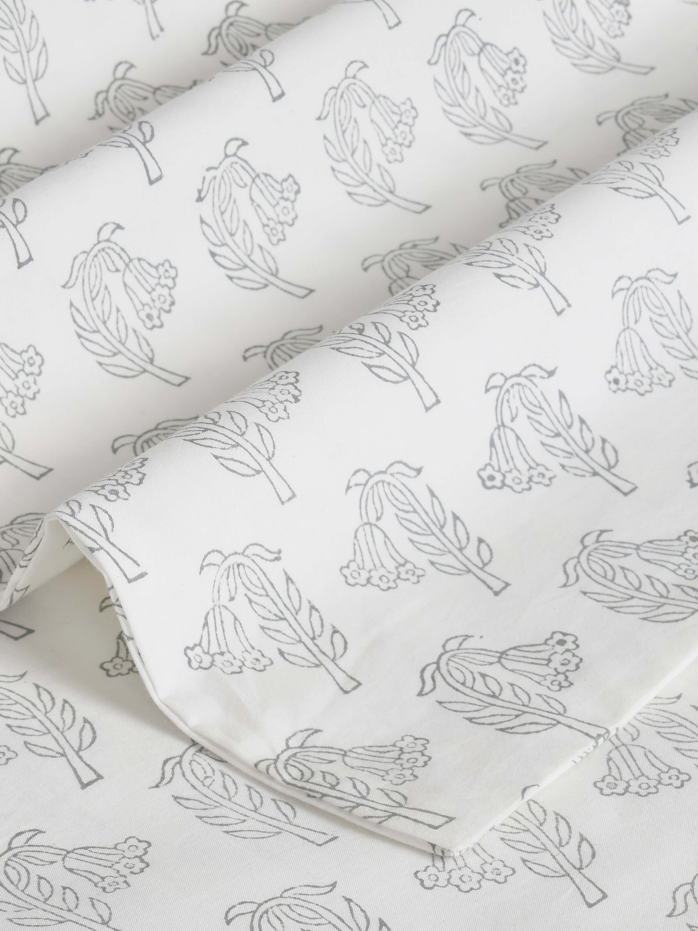 Detailed view of Pratidin Grey Floral Sprig Cotton Sanganeri Block Printed King Bedsheet, focusing on the floral sprig pattern and color harmony.