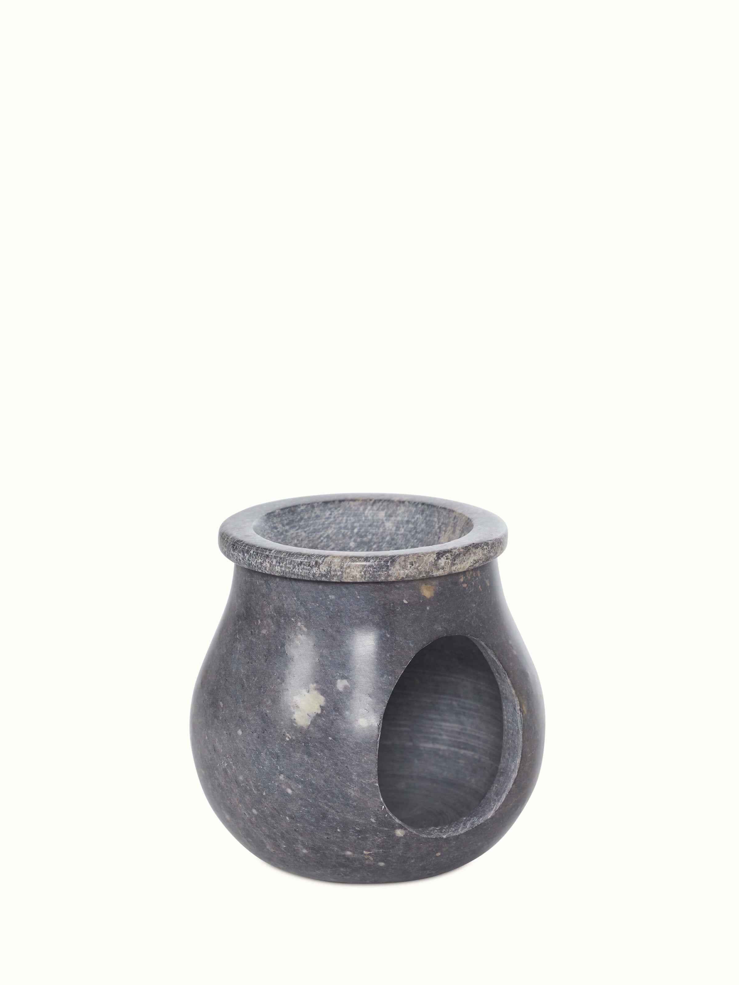 Angled view of natural carved stone diffuser from Swadesh, emphasizing the intricate detailing and smooth finish.