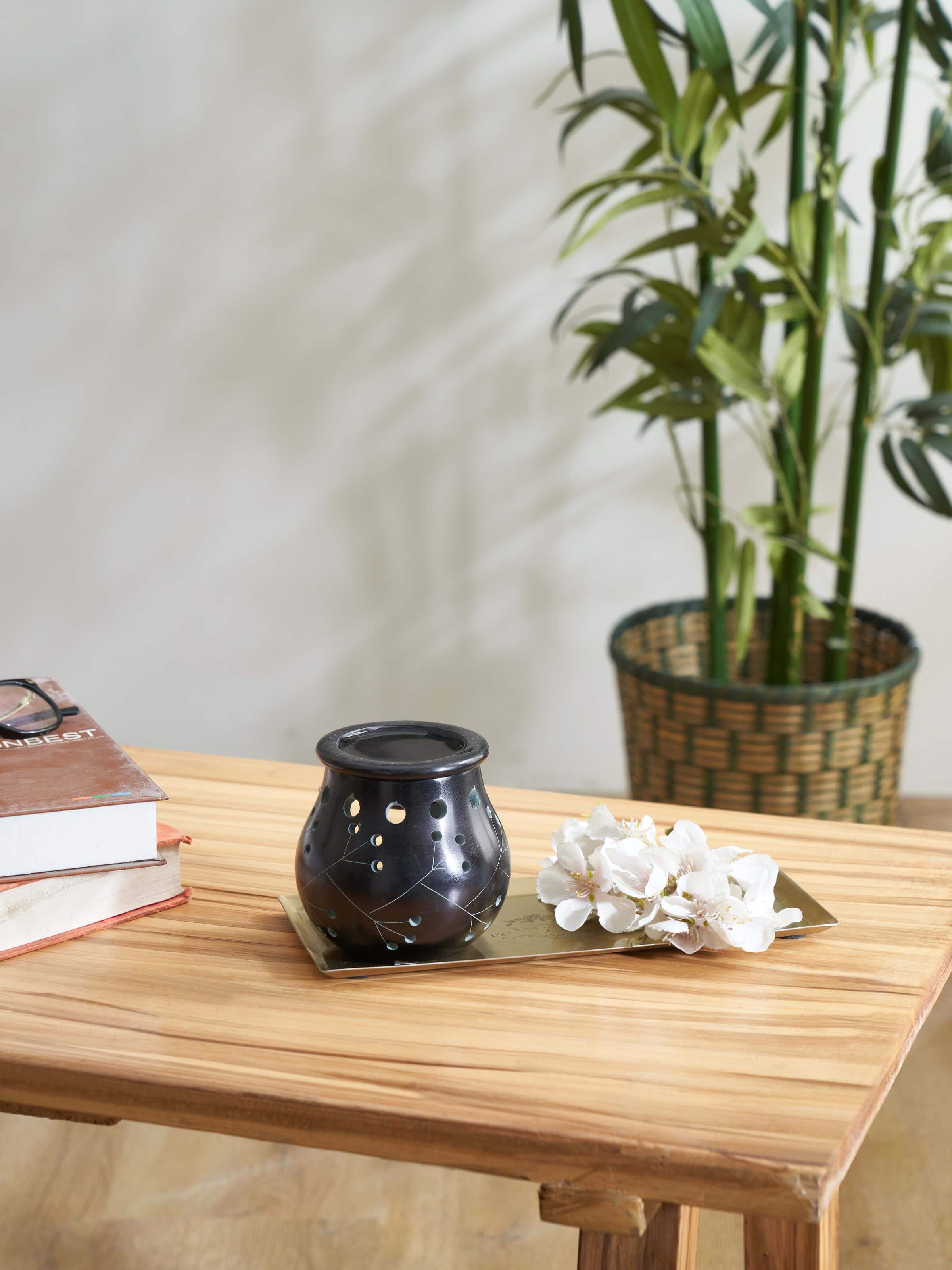 Side view of Carved Stone Diffuser in Black Color, showcasing the shape and texture of the stone
