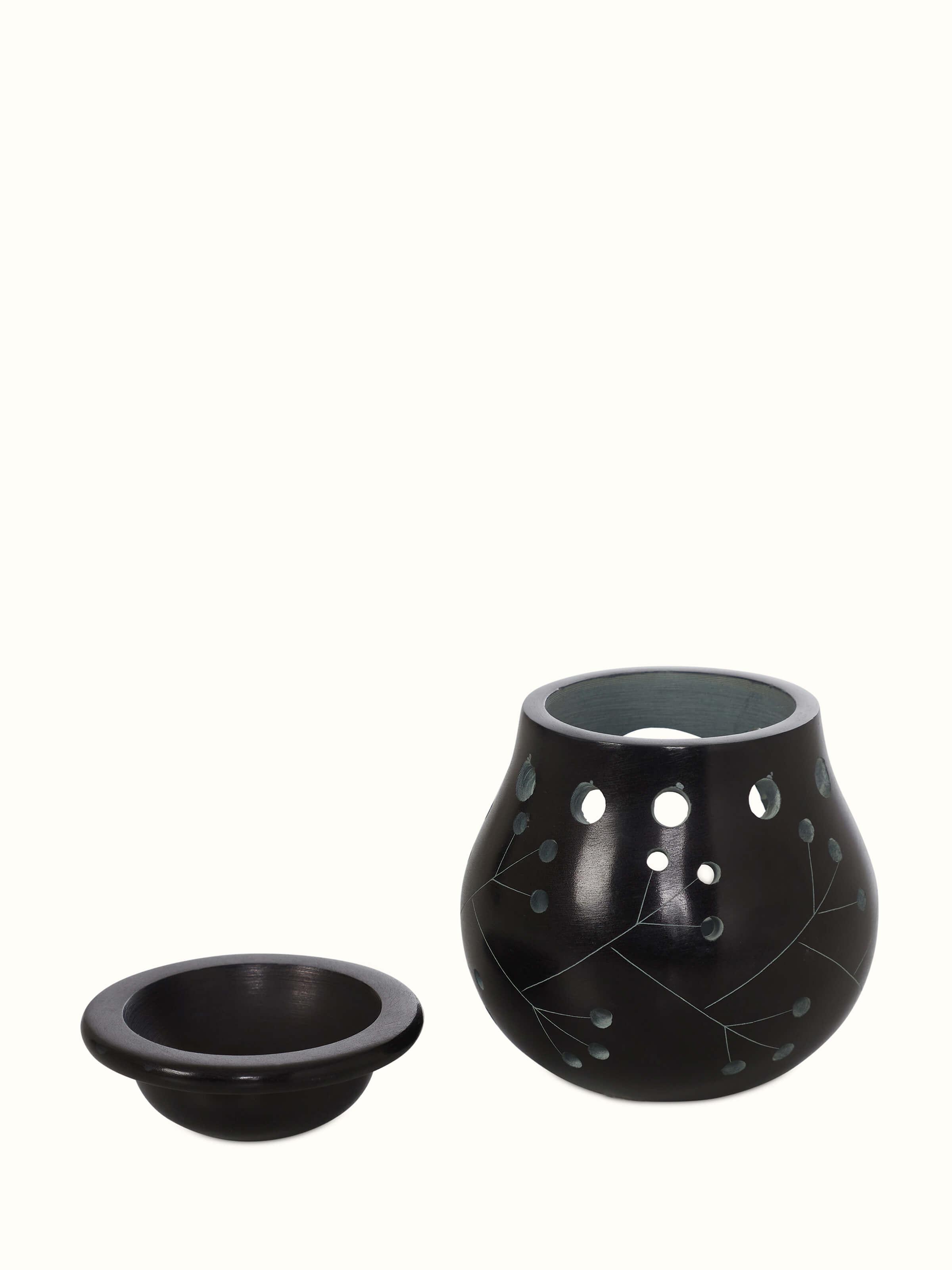 Angled view of Carved Stone Diffuser in Black Color, showcasing the three-dimensional aspect and decorative carvings