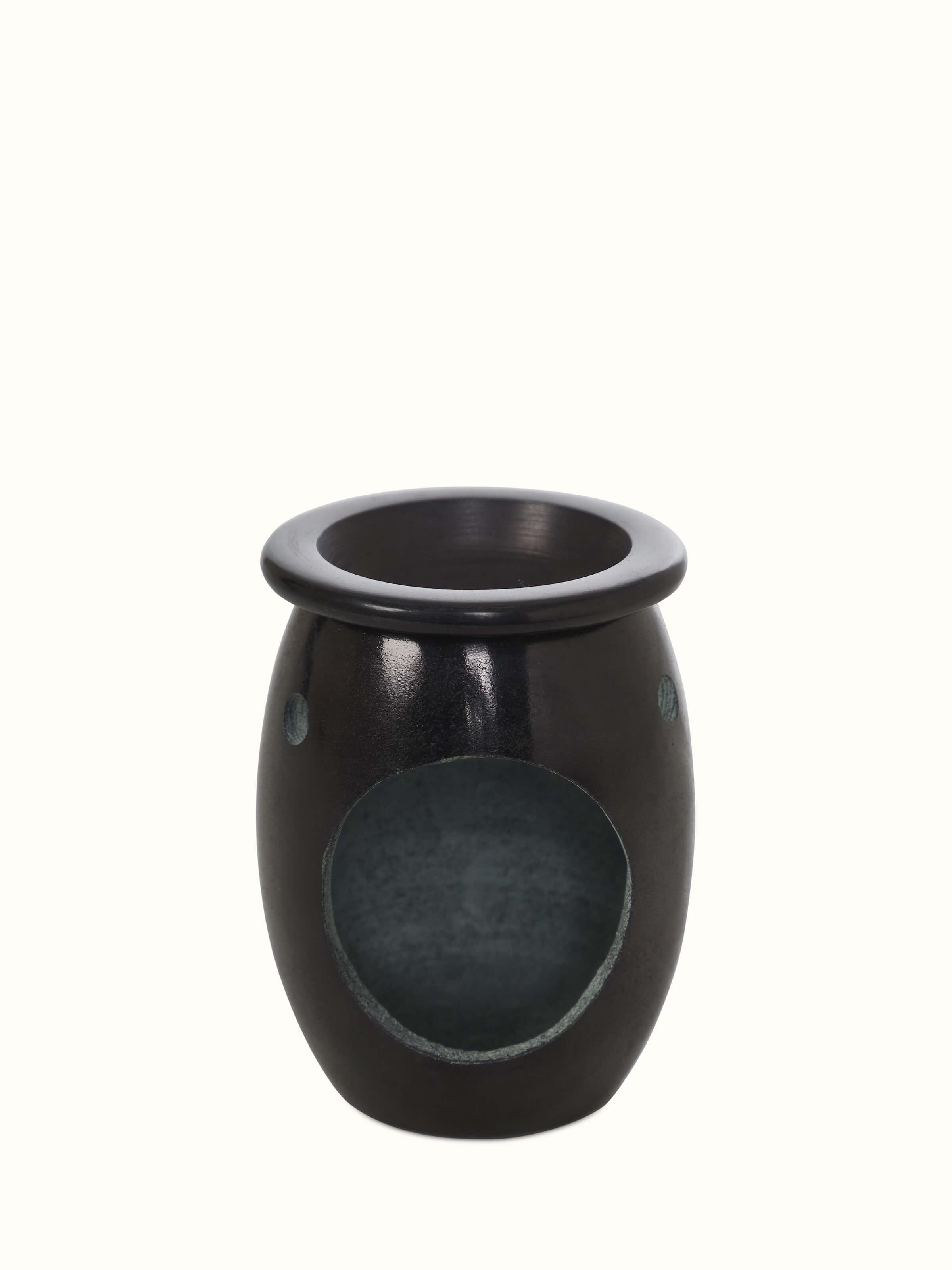 Detailed close-up of the carved stone diffuser, highlighting the fine carvings and stone texture.