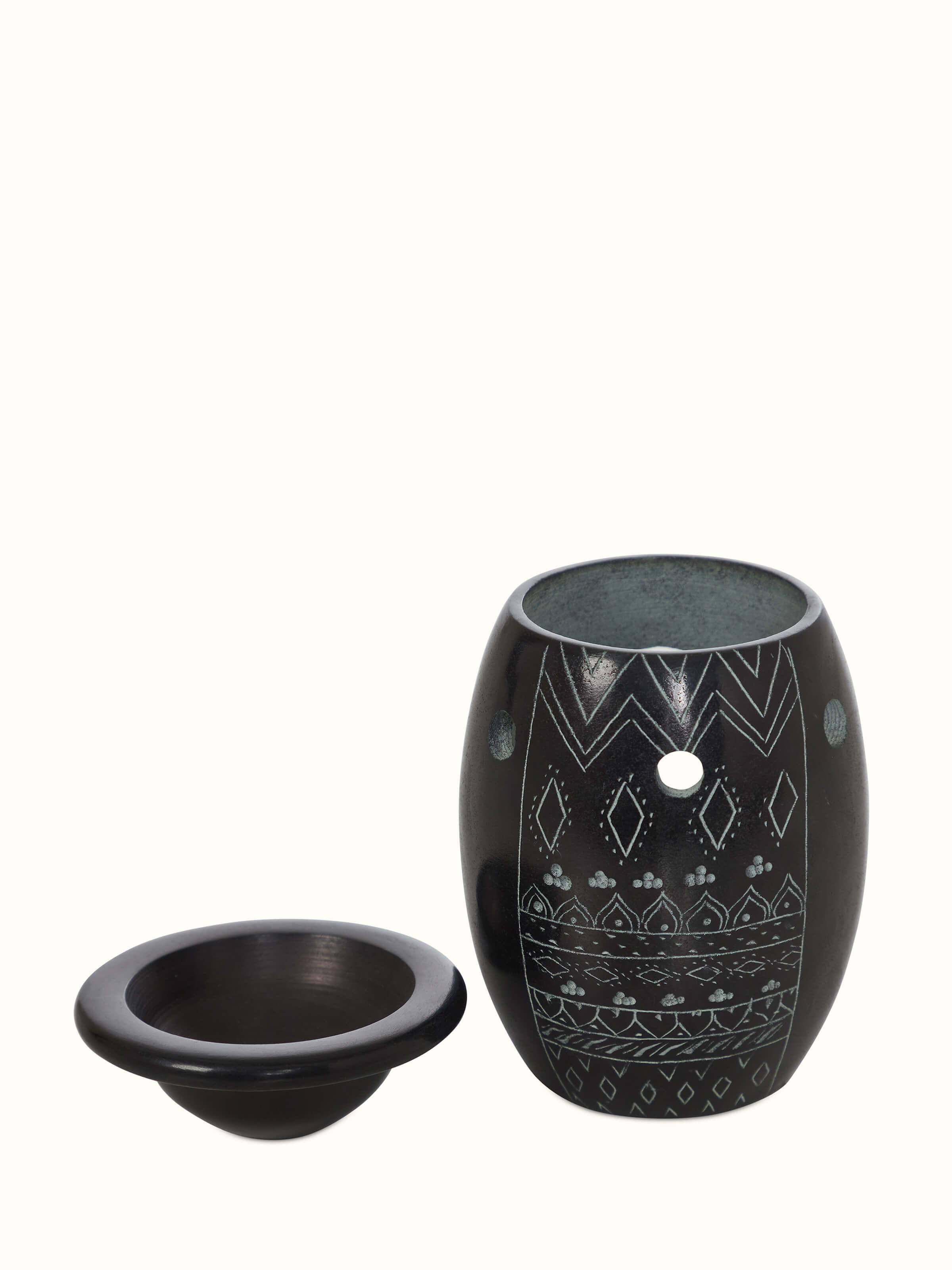 Top view of the carved stone diffuser, showcasing the overall design and detailed carvings.